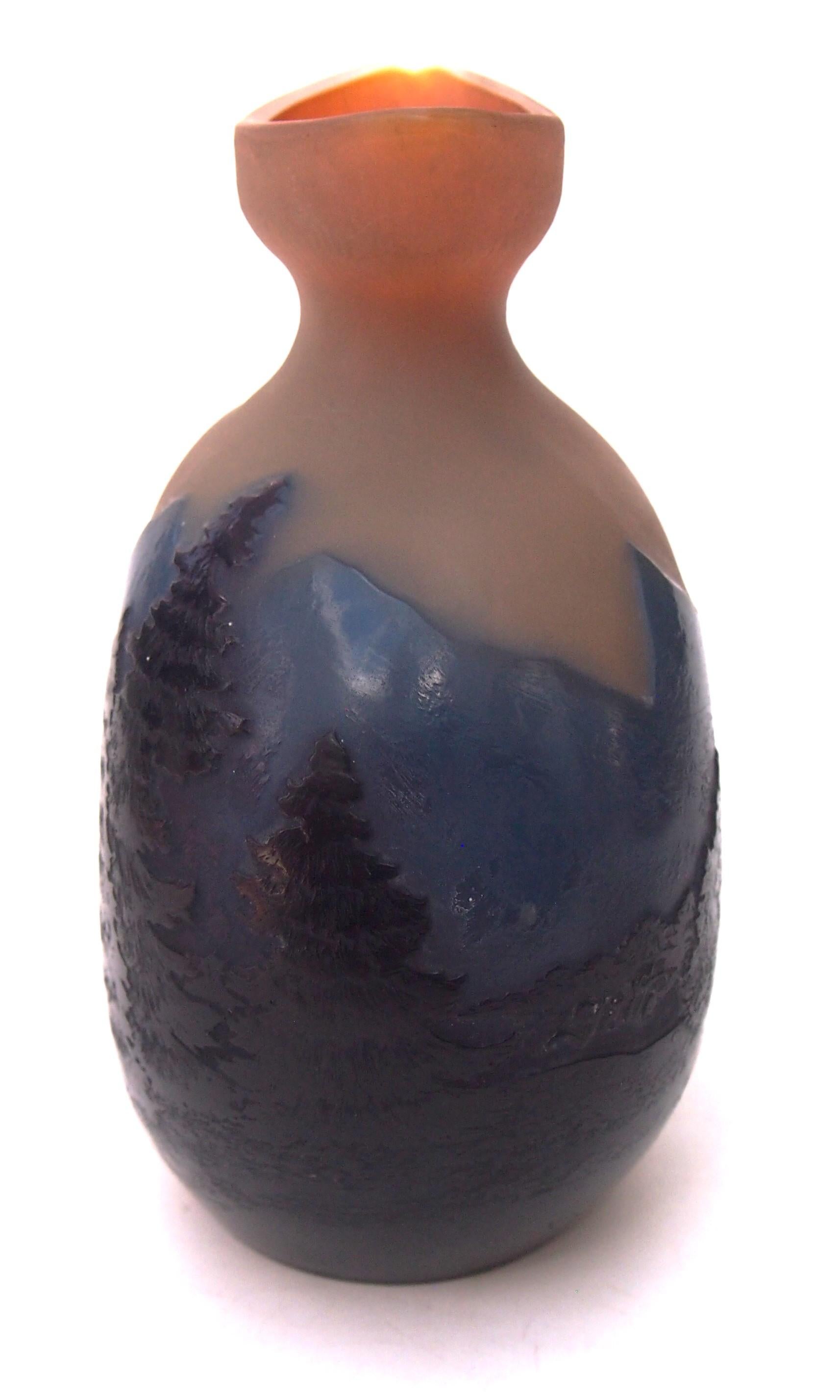 Exceptional Art Nouveau Emile Galle Cameo 'blue mountain' landscape vase, in the classic shape of an eye bath topped moon flask. The vase is very dark purple (looking black) over dark blue over opal orange. It depicts finely detailed dark trees