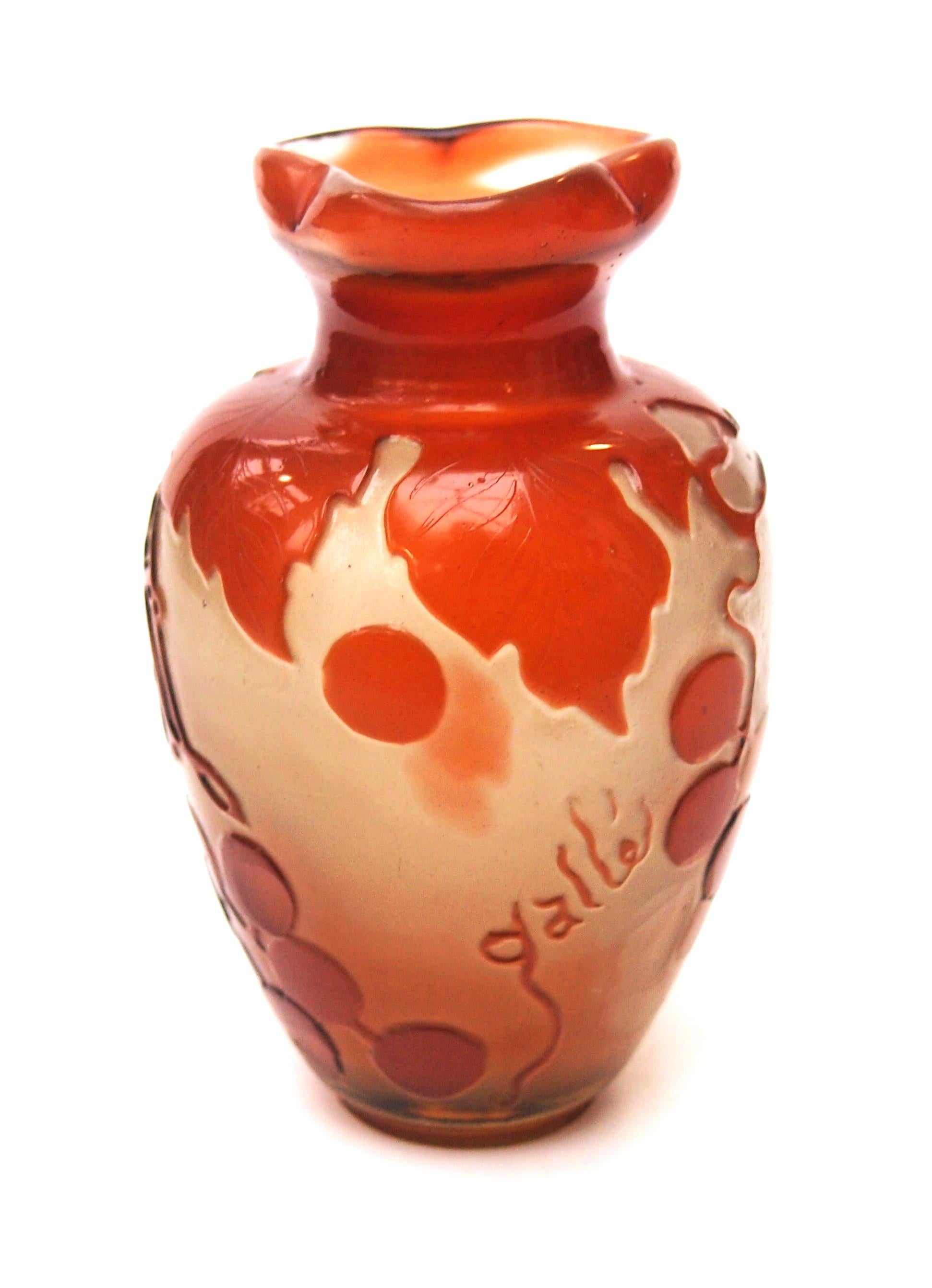 Super early small Emile Galle fire polished orange over clear cameo vase featuring trailing, downward hanging, grapes on sinuous vines -a classic early image. The vase is also a classic early Emile Galle shape with a bulbous body and a narrow neck