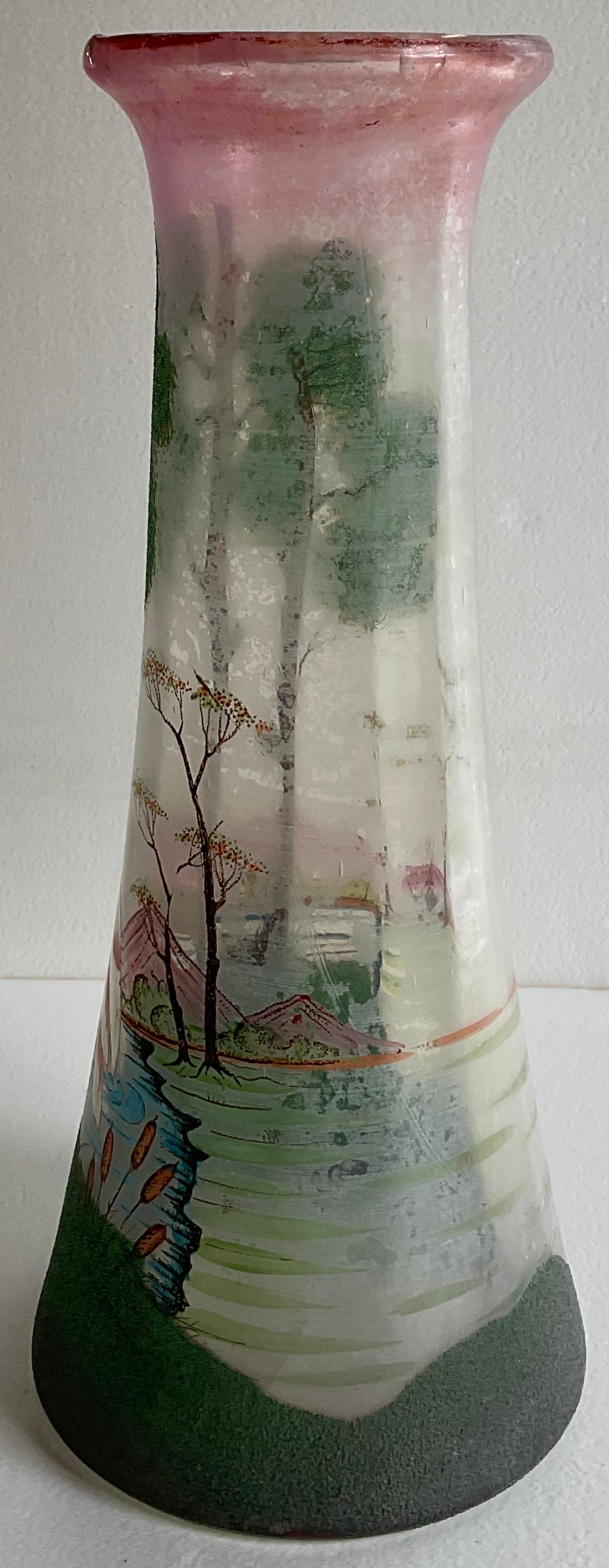 A beautiful French enameled glass vase from the Art Nouveau period, circa 1930.
Intricately detailed work is by François- Théodore Legras.

The tube of this vase is slightly enlarged and has a pink/purple background. It is hand-decorated with trees,