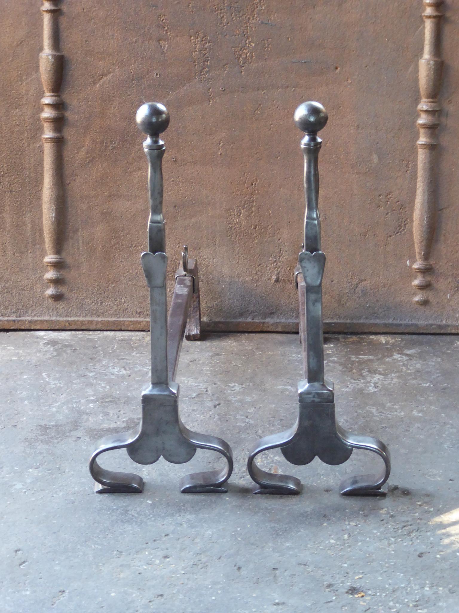 Late 19th or Early 20th century French Art Nouveau andirons made of wrought iron. The andirons have spit hooks to grill food. The condition is good.