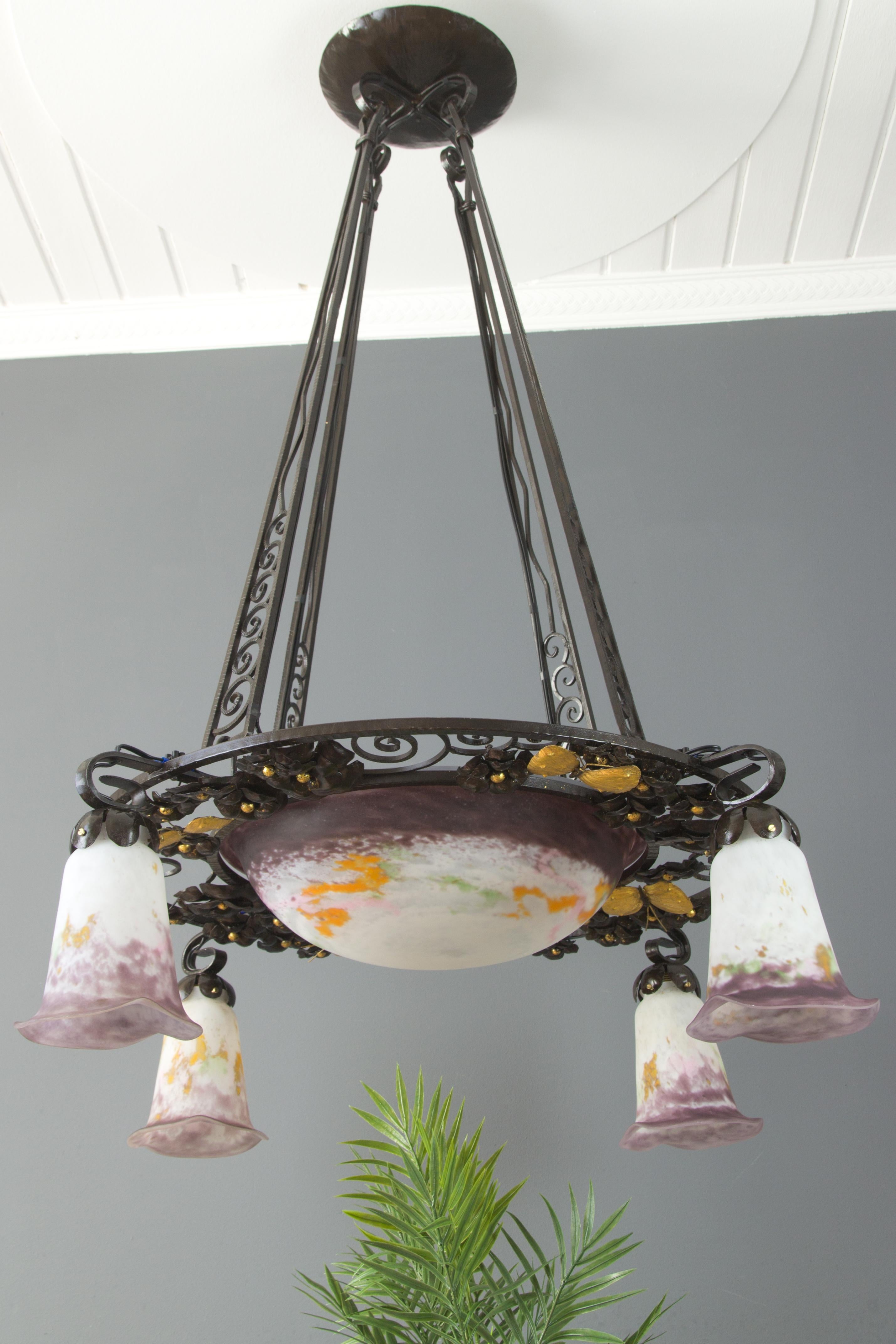Stunning and large French Art Nouveau chandelier in purple, yellow, green, and white glass paste, consisting of a central bowl and four tulip sconces by Verreries d'Art Lorrain. Glass shades signed 