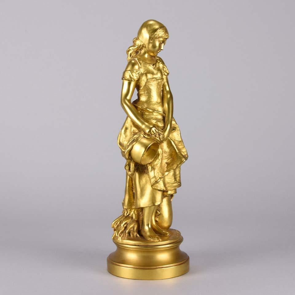 A very charming Art Nouveau early 20th century gilt bronze figure of a young beauty cleaning her kitchen ware whilst standing in a coy pose. The surface of the sculpture with excellent hand finished detail and good color, signed A. Gaudez.

Adrien