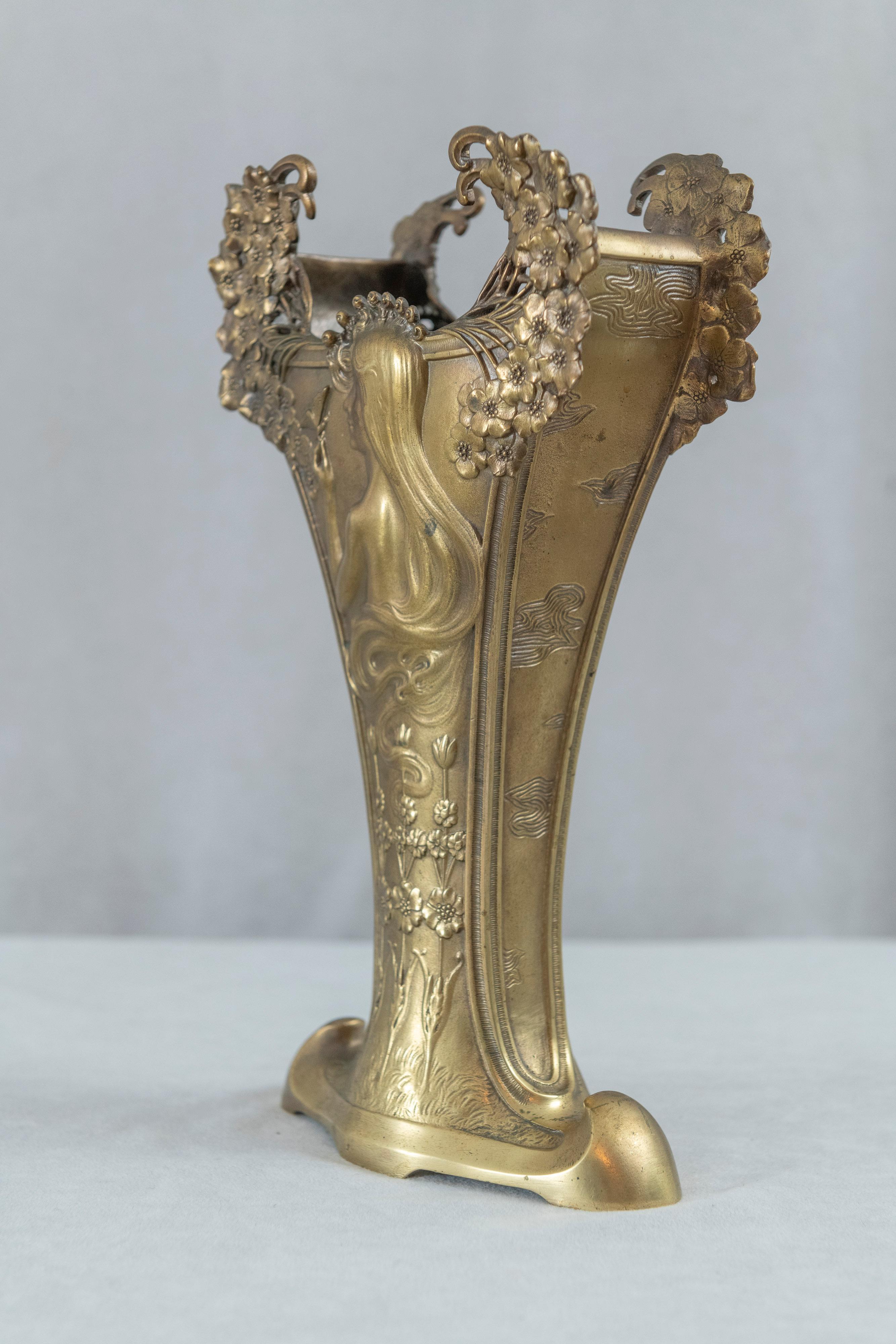  If we were going to show someone what an art nouveau bronze looks like, we might very well start here. This truly magnificent and exemplary vase has all the beautiful qualities of the art nouveau movement. Willowy flowers, sinewy lines, and the