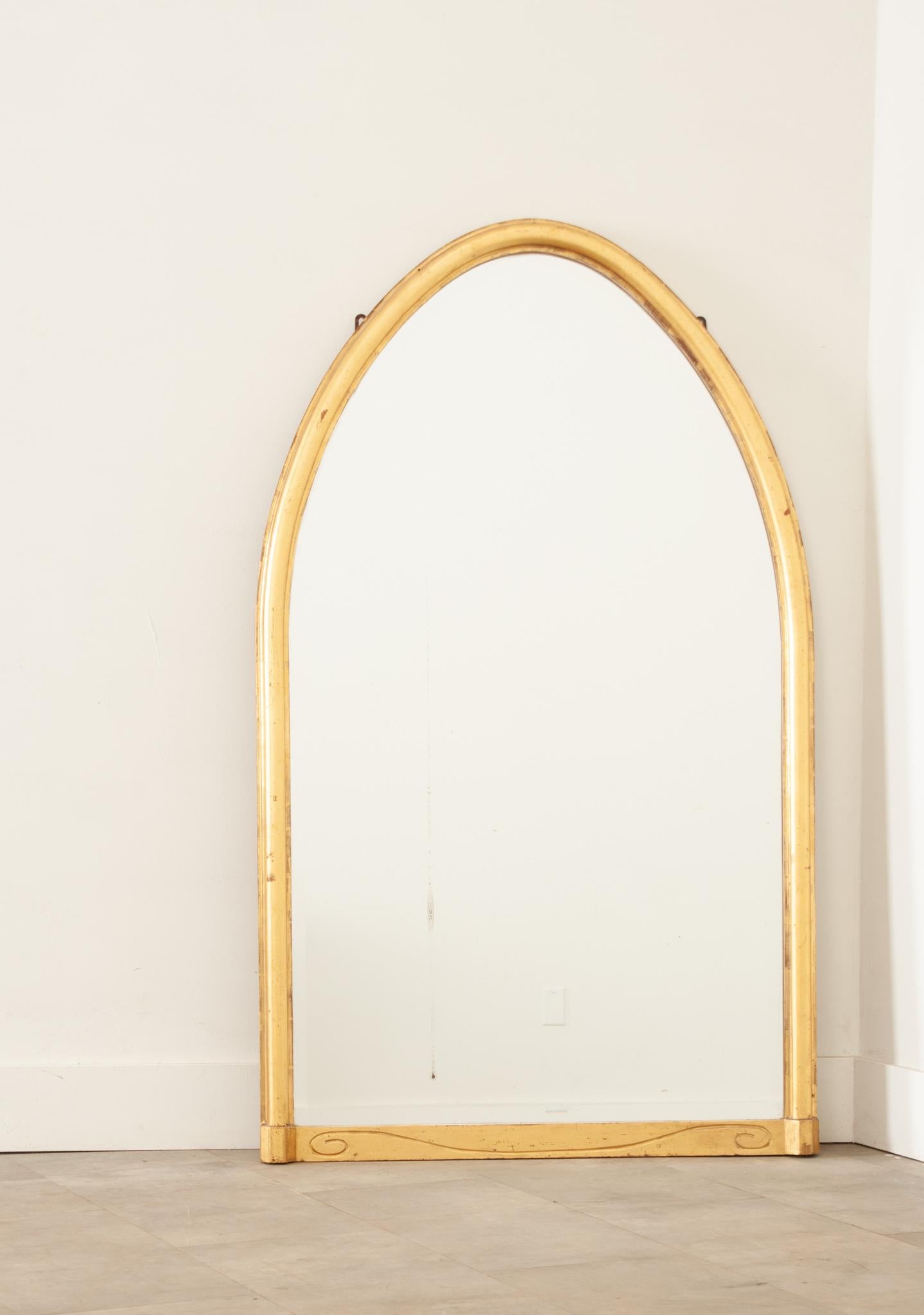 A fantastic gold gilt Art Nouveau mirror with the original beveled mirror plate. The gilt is in good condition with minimal wear. Below the mirror is a nicely carved C scroll detail. The mirror plate is in great condition with some minor