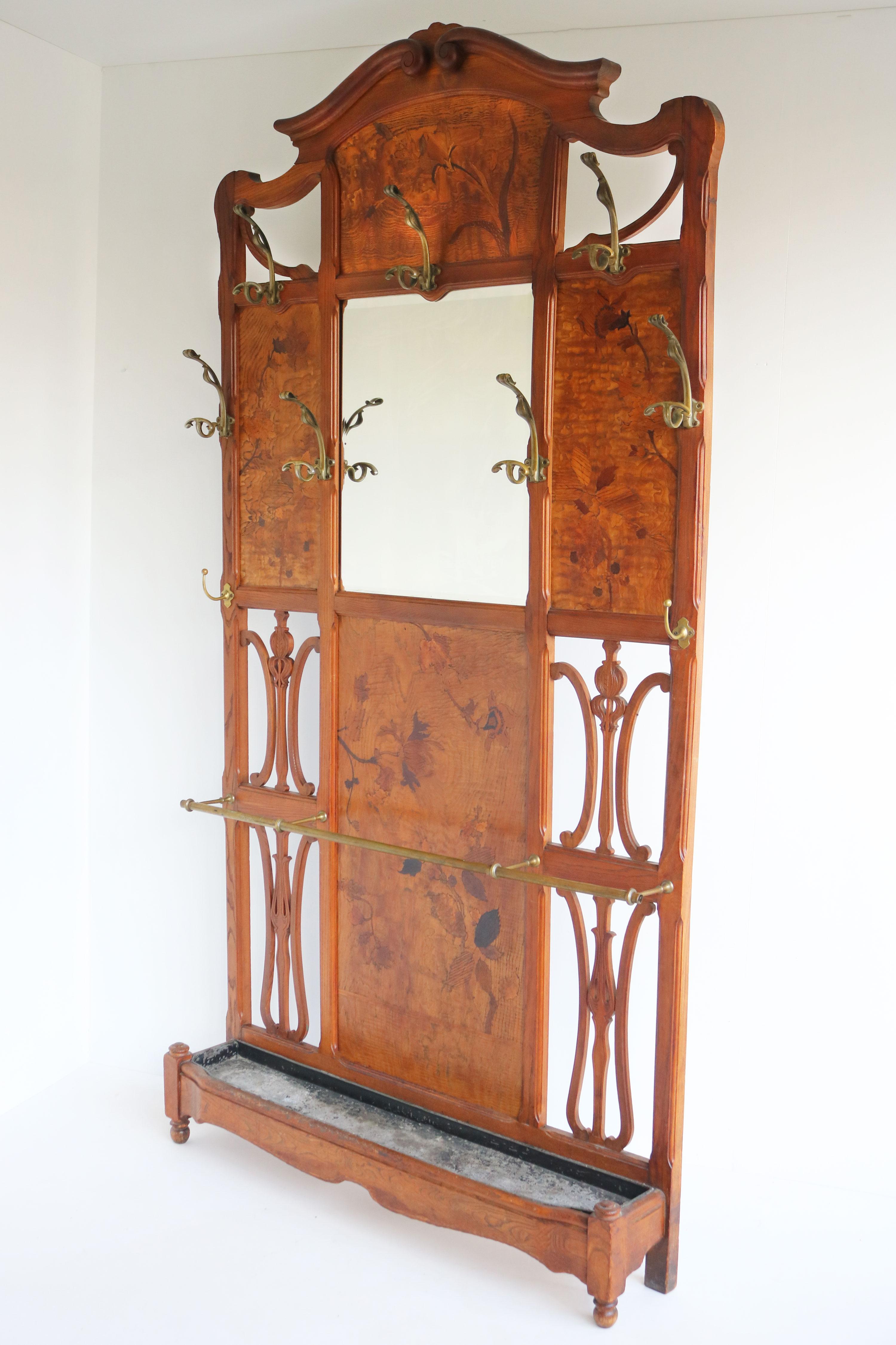 Enhance your hallway decor with the elegant and functional Emile Gallé hallway tree coat rack. 
Featuring exquisite craftsmanship and a timeless design. the coat rack comes with its original 9 art nouveau bronze hooks, that are just simply