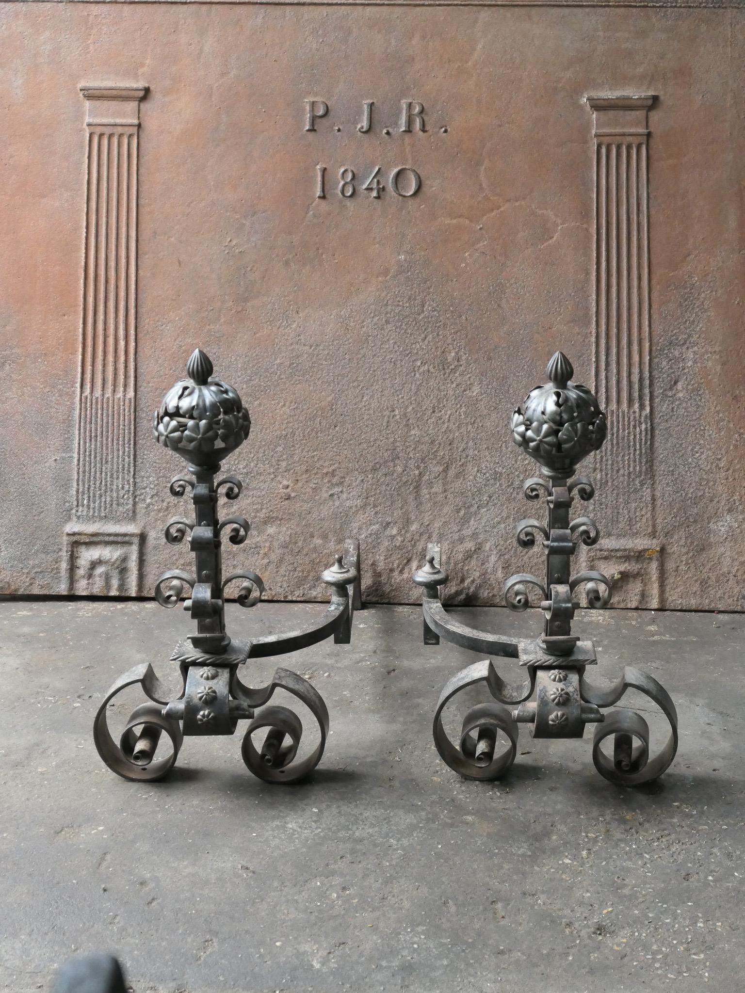 Early 20th century French Art Nouveau andirons made of wrought iron. The andirons are richly decorated. The condition is good.