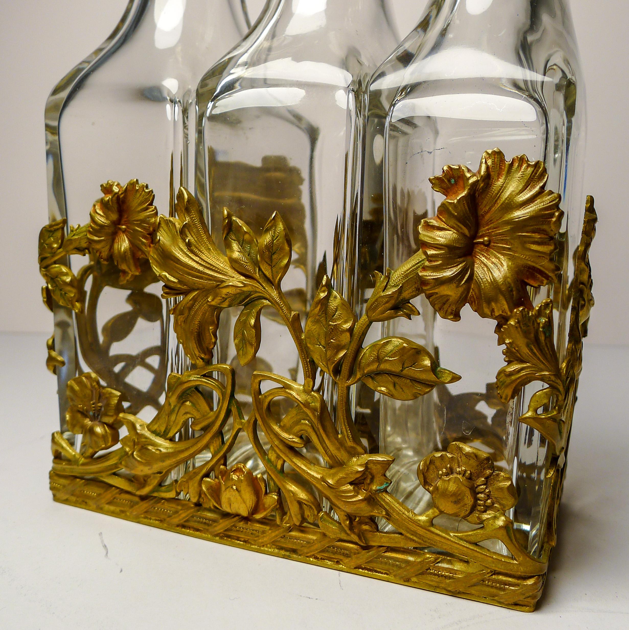 A stunning antique French decanter set; small decanters perhaps for Liqueurs or large scent / perfume bottles - large for concentrated perfume so would have been more for Eau de Toilette / Colognes.

The caddy in which they sit is a wonderful art