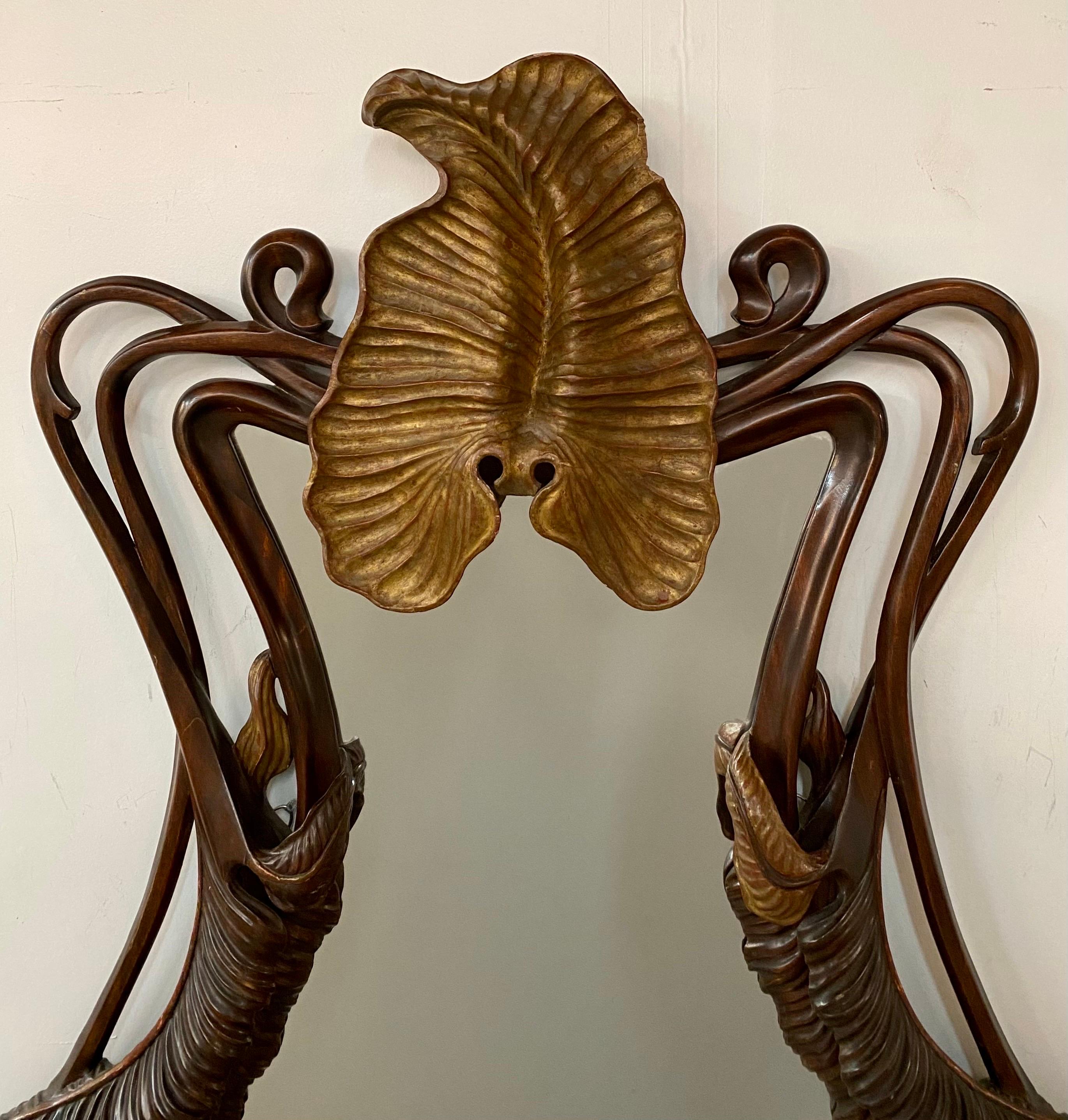 An antique French Art Nouveau  Mahogany wood carved mirror, gracefully fashioned in the likeness of a butterfly. At the heart of this mirror's allure lies its hand-carved frame meticulously crafted to emulate the ethereal and delicate wings of a
