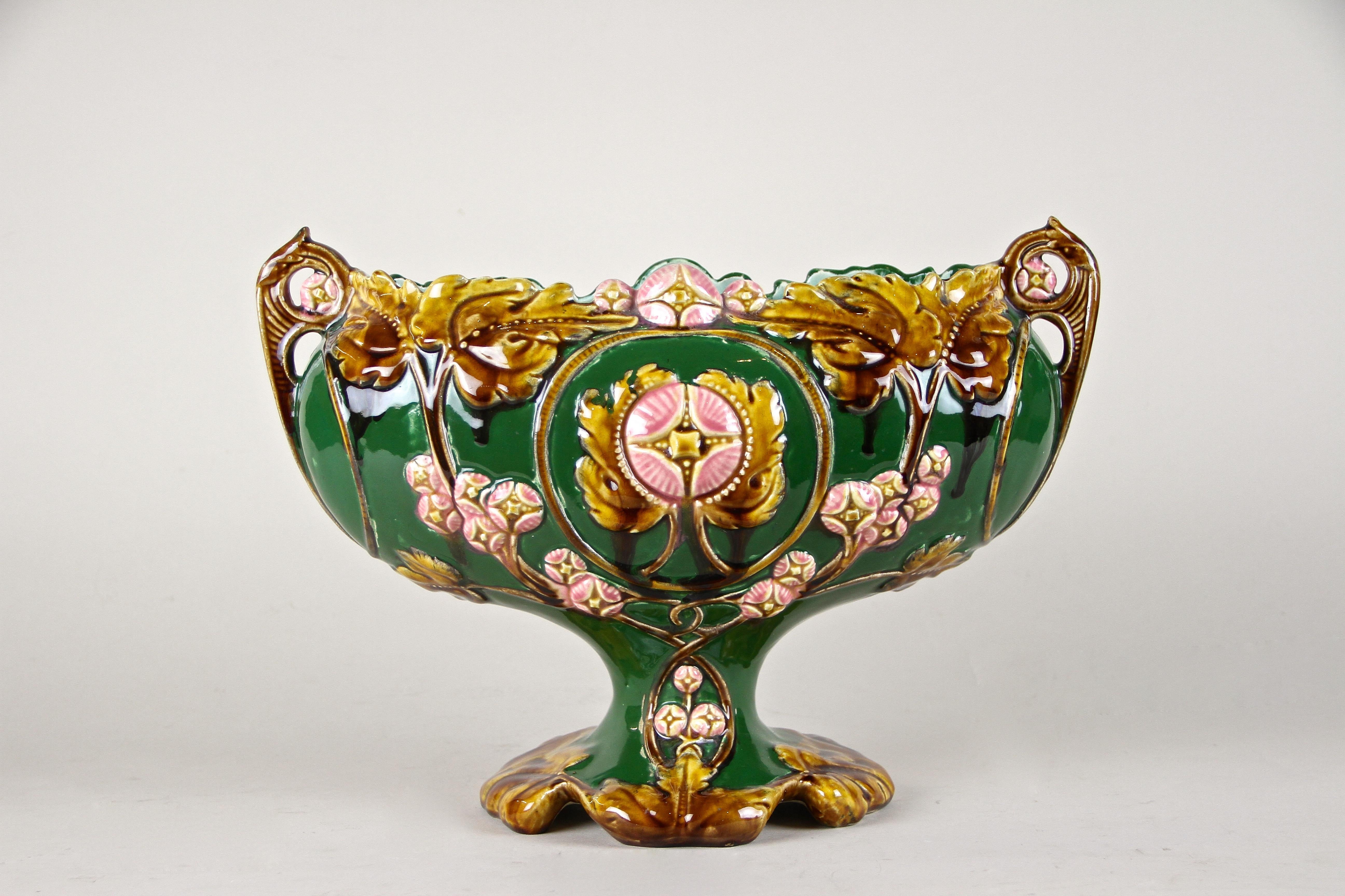 Large Majolica jardinière out of France from the early Art Nouveau period circa 1900. The beautiful designed green colored body impresses with an organic shape adorned by a floral theme, showing a lovely coloration in different green, brown, yellow