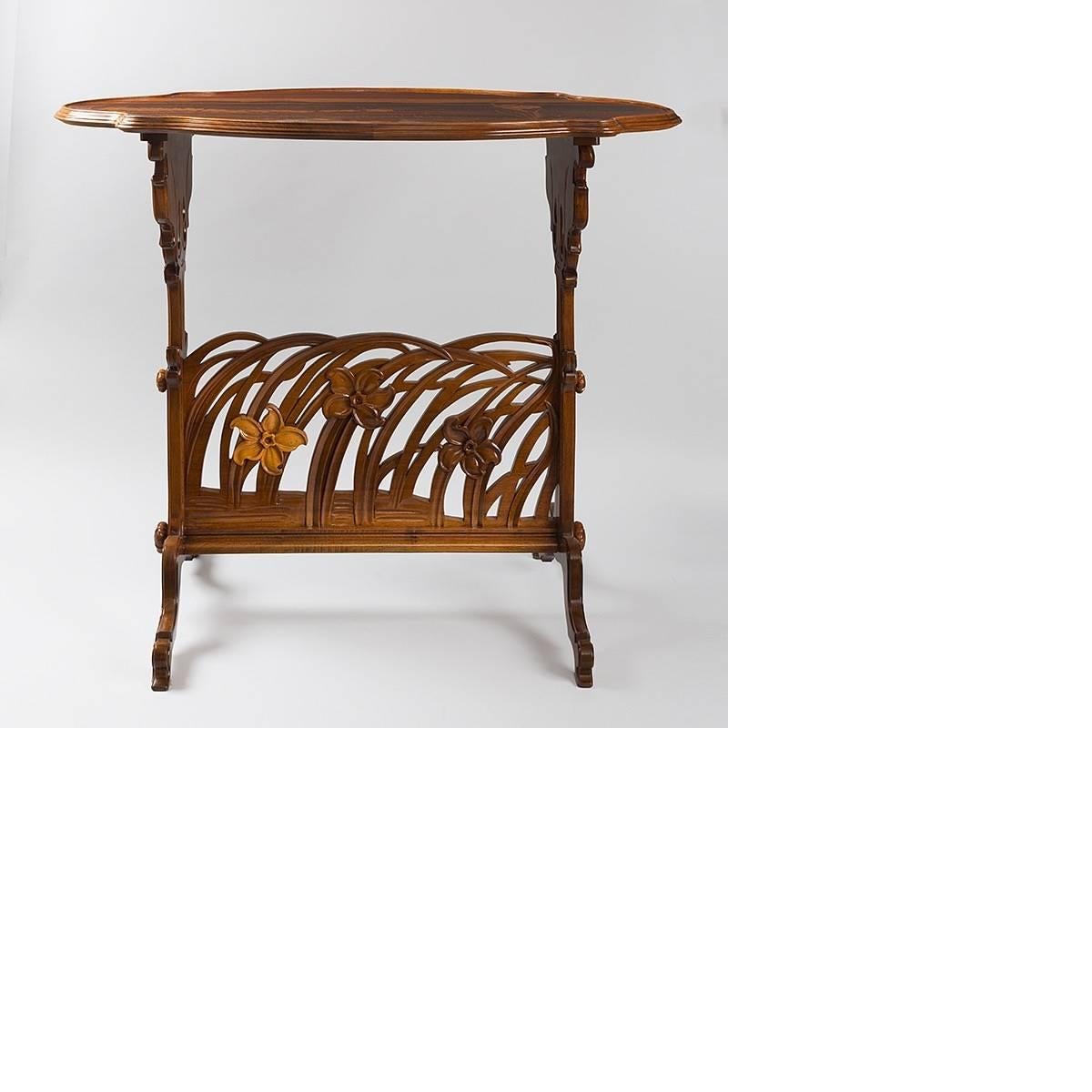 A French Art Nouveau carved walnut and fruitwood marquetry 