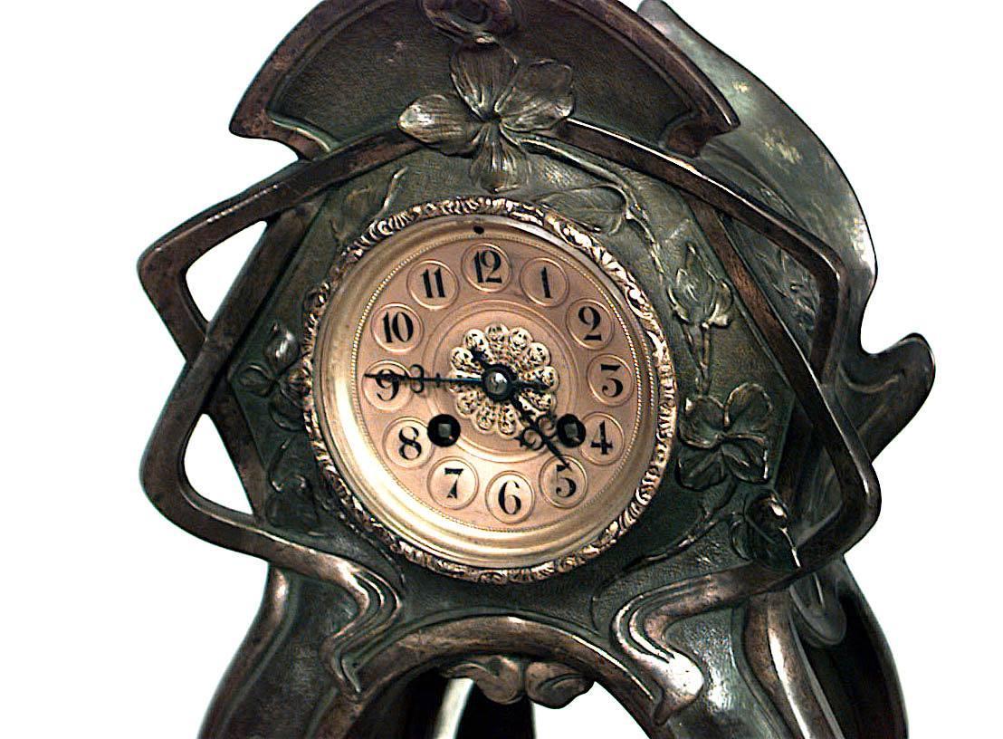 French Art Nouveau metal mantel clock with green patina and mirrored center. (Not working)
