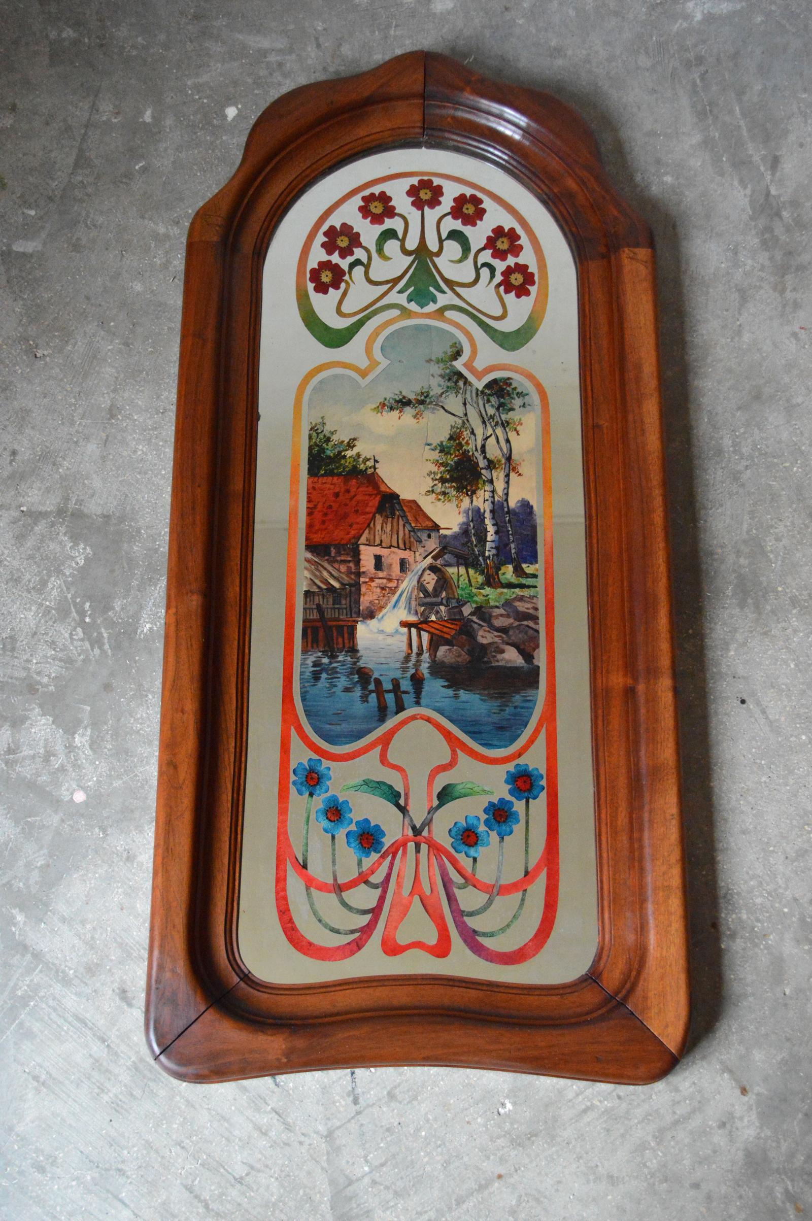 Wonderful mirror.

Carved solid walnut frame. The mirror is hand painted under the glass. The painting represents a landscape, there is a water mill. There are also flowers and shade variations.

Art Nouveau, circa 1900.

Beautiful