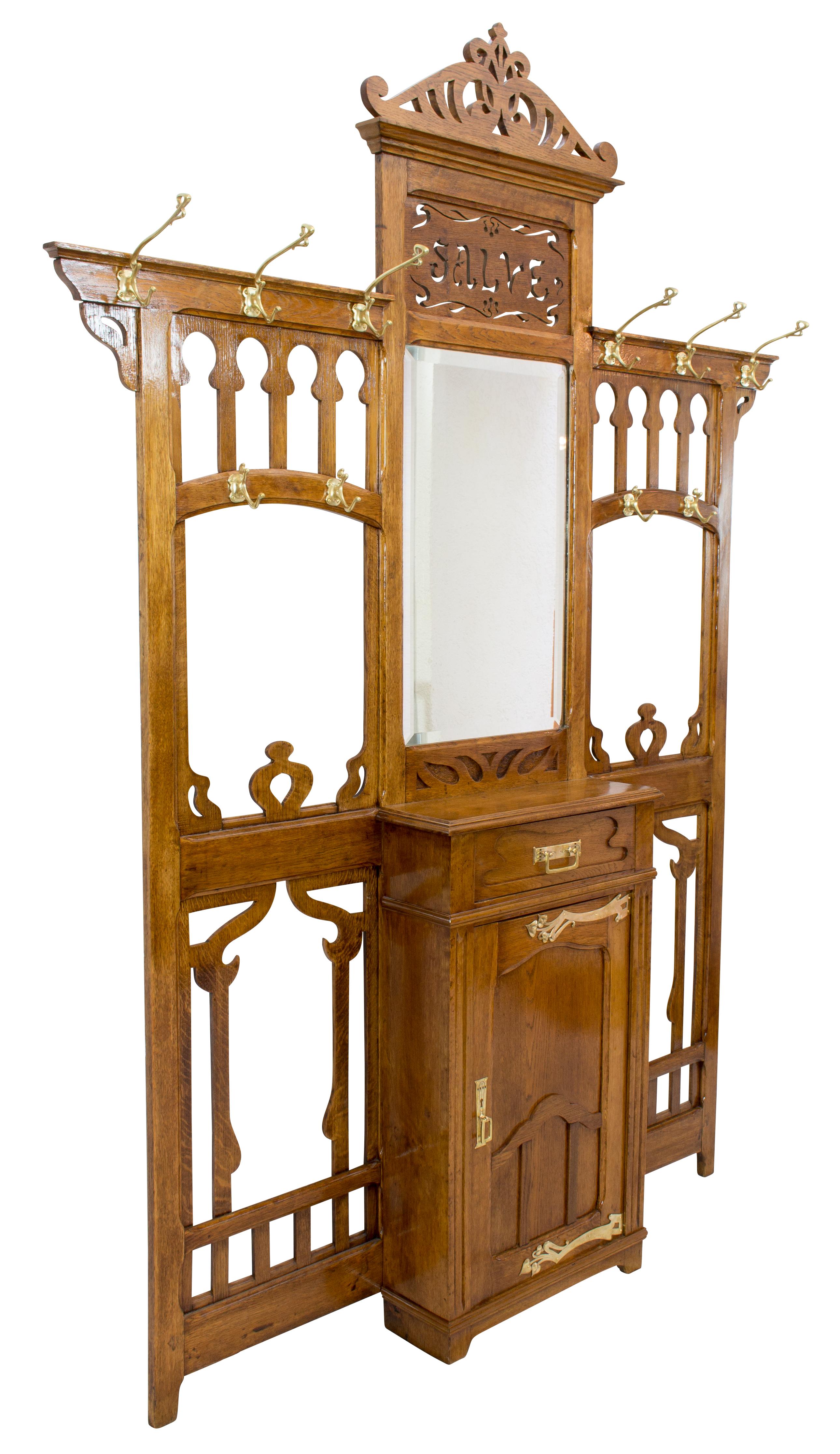 Very beautiful imposing wall wardrobe from the Art Nouveau period end of the 19th century from France. The wardrobe is made of oakwood and covered with original floral brass applications, fittings & hooks. The mirror with a facet cut dates from that