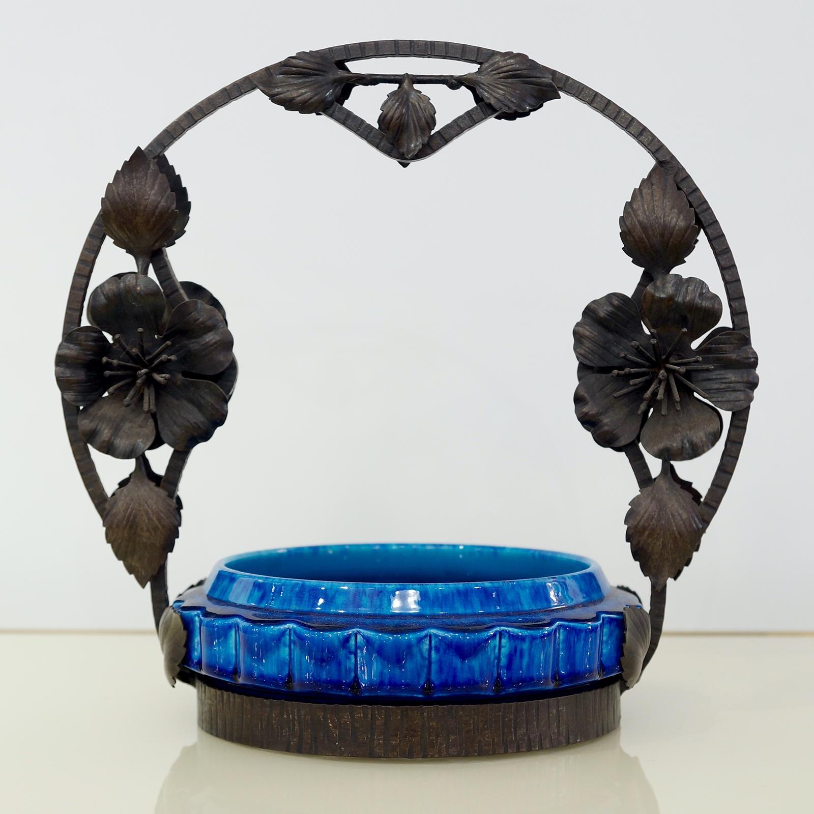 Cirac 1910, unique Art Nouveau bowl compote decorated like a summer basket with a wrought black iron handle decorated with nicely detailed flowers and leaves. The bowl in ceramic vibrant turquoise tint blue Sevres enamel glaze is detachable, signed