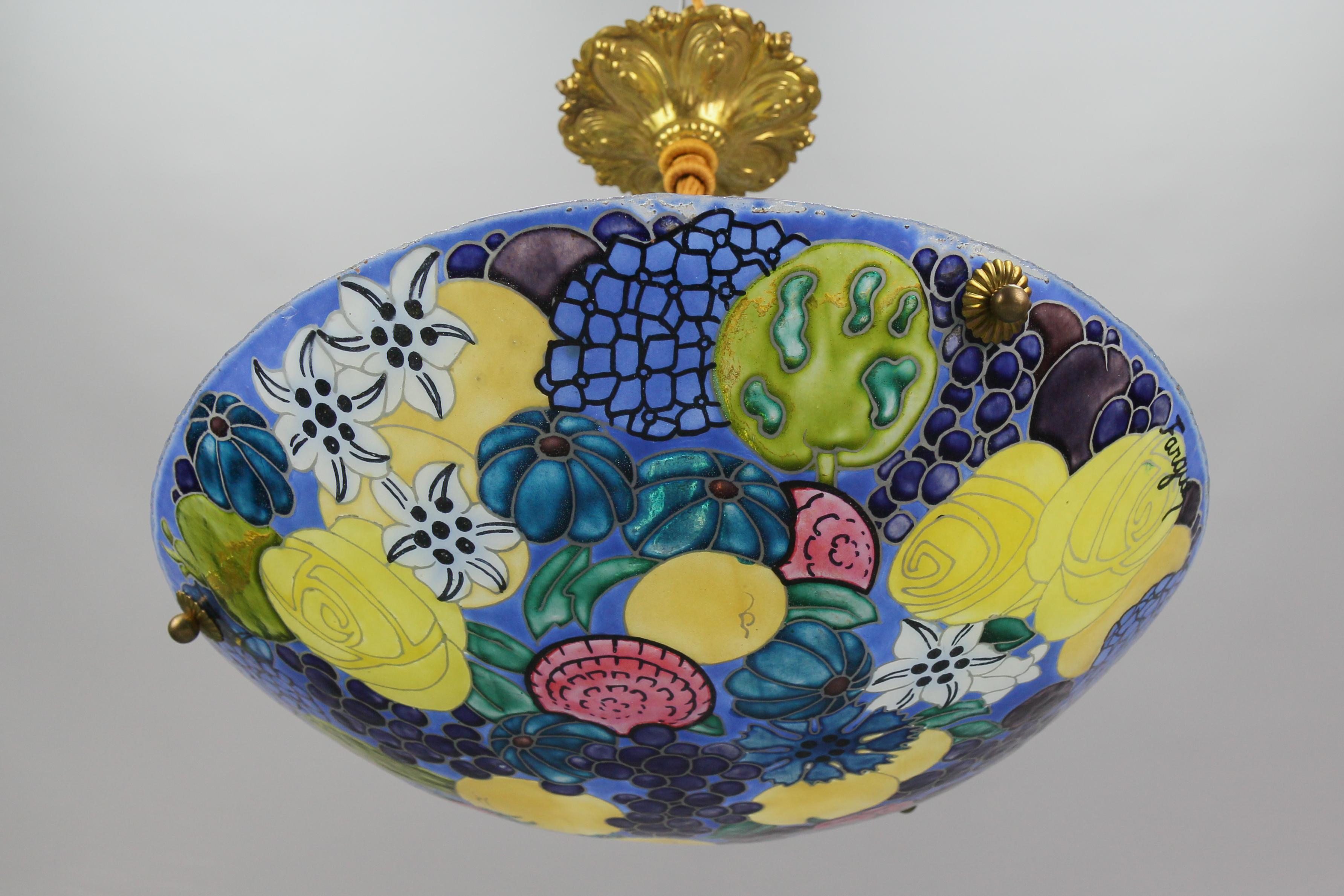 French Art Nouveau painted enameled glass pendant light with flower and fruit motifs, signed Fargue, from the 1930s.
A wonderful pendant ceiling light fixture from circa the 1930s. The beautifully painted enameled glass bowl features flower and