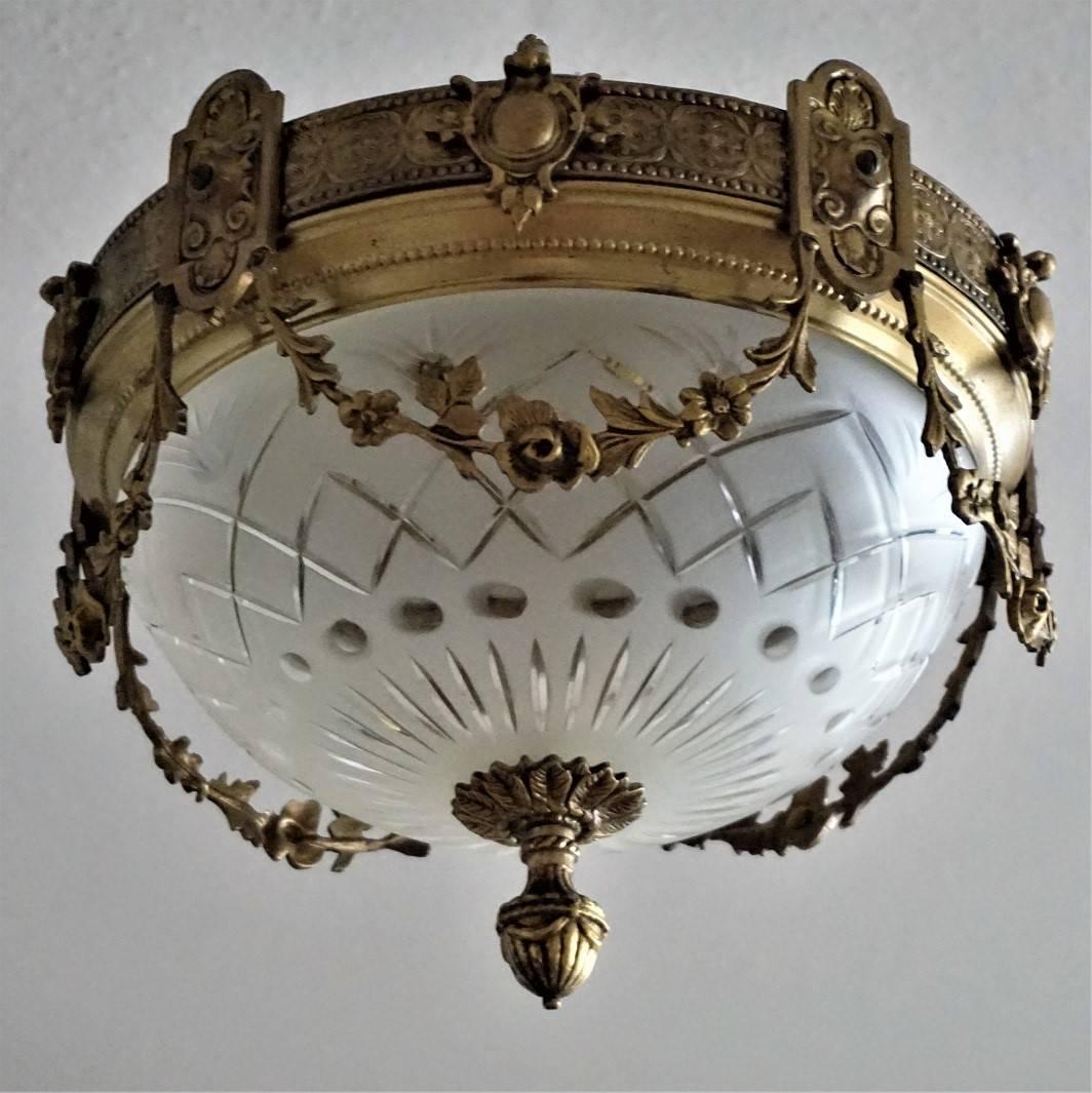 A wonderful gilt bronze and cut-glass two-light ceiling fixture decorated with fine ornaments and garlands, France, early 20th century.
In very good condition - original cut-glass shade without damages, bronze with beautiful patina.
Two large size