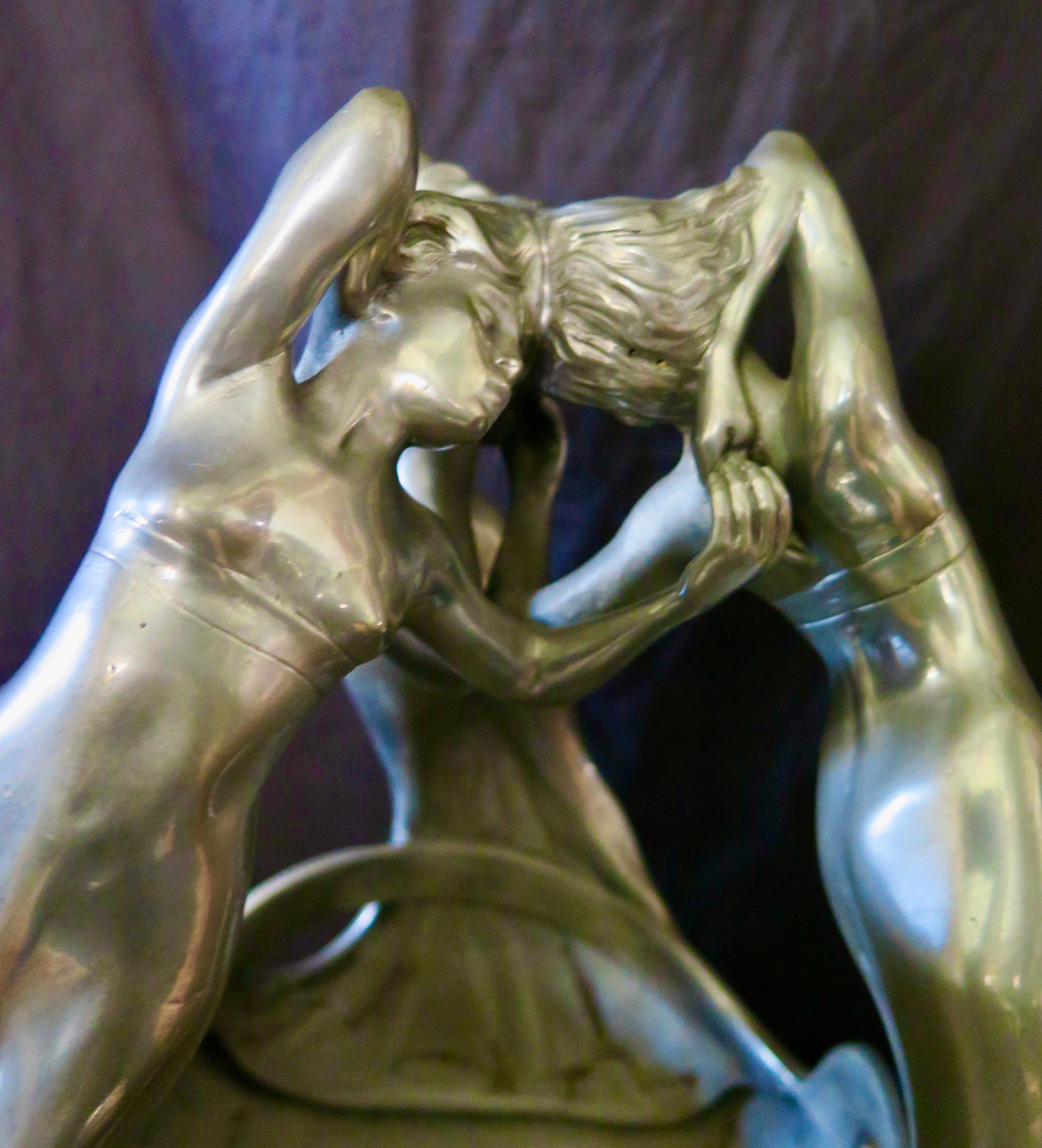 This wonderful French late 19th century Art Nouveau centerpiece features three sensuous maidens/muses dancing in a tight circle. The period pewter center is beautifully sculpted with complete figured maidens hand in hand & touching heads as they