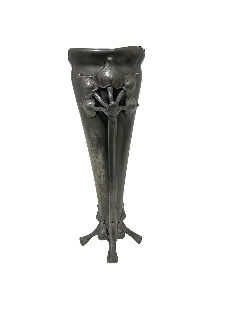 French Art Nouveau pewter vase, ca 1900

A French Art Nouveau vase, made of pewter in beautiful Art Nouveau scene of flowers, raised on 4 legs. A tapered, but rounded model with two arms, representing the stem of the plant with five flowered buds at