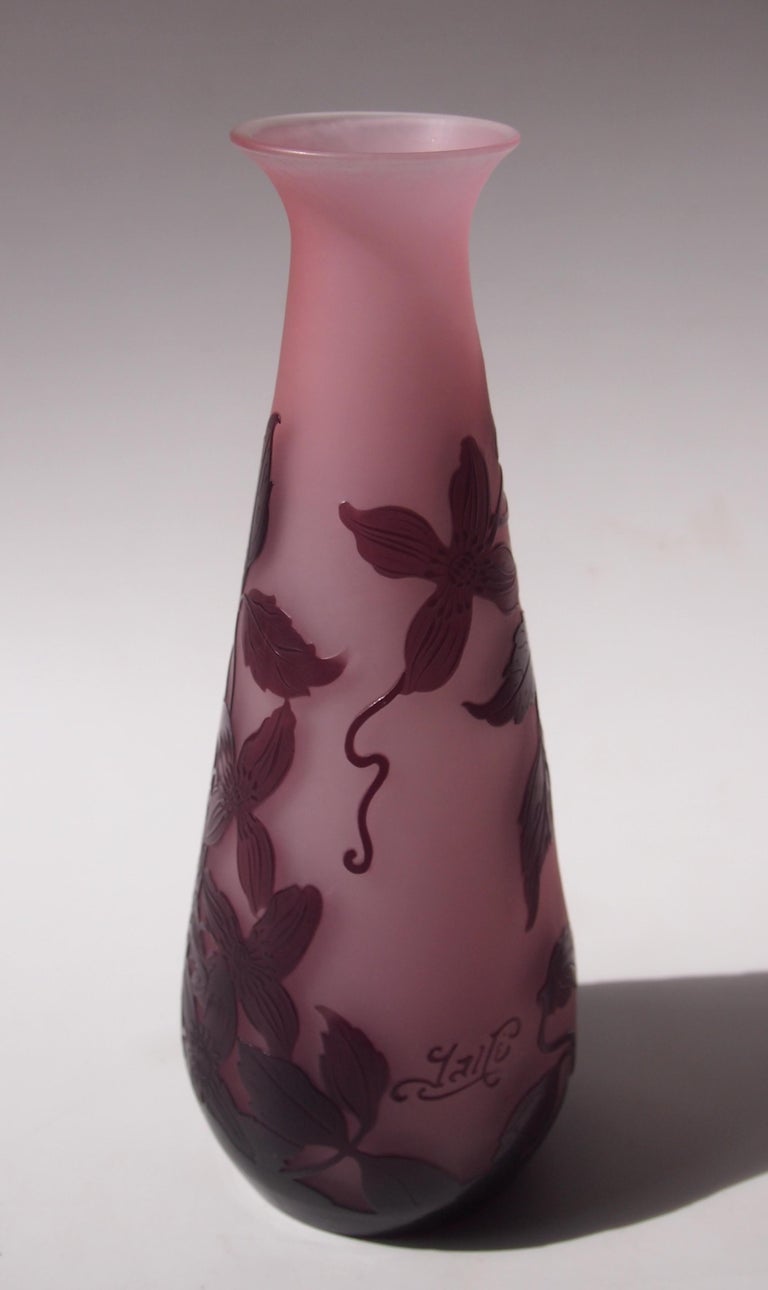 Classic signed French Art Nouveau Emile Galle cameo glass vase in purple over pink, depicting climbing flowers, circa 1900.

Emile Galle was probably the greatest glass maker of all time and one of the founding father's of the Art Nouveau movement.
