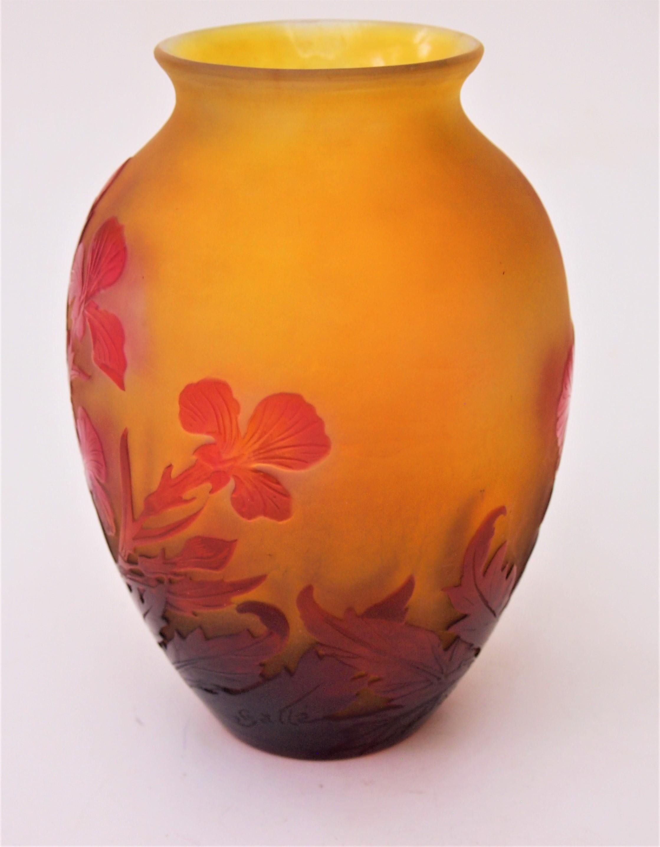 French Art Nouveau Emile Gallé  ball shaped cameo vase depicting Irises in reds over orange with a slightly flared opening. It has fine internal polishing to highlight the red in the irises, (this is sometimes called window pane technique one of the