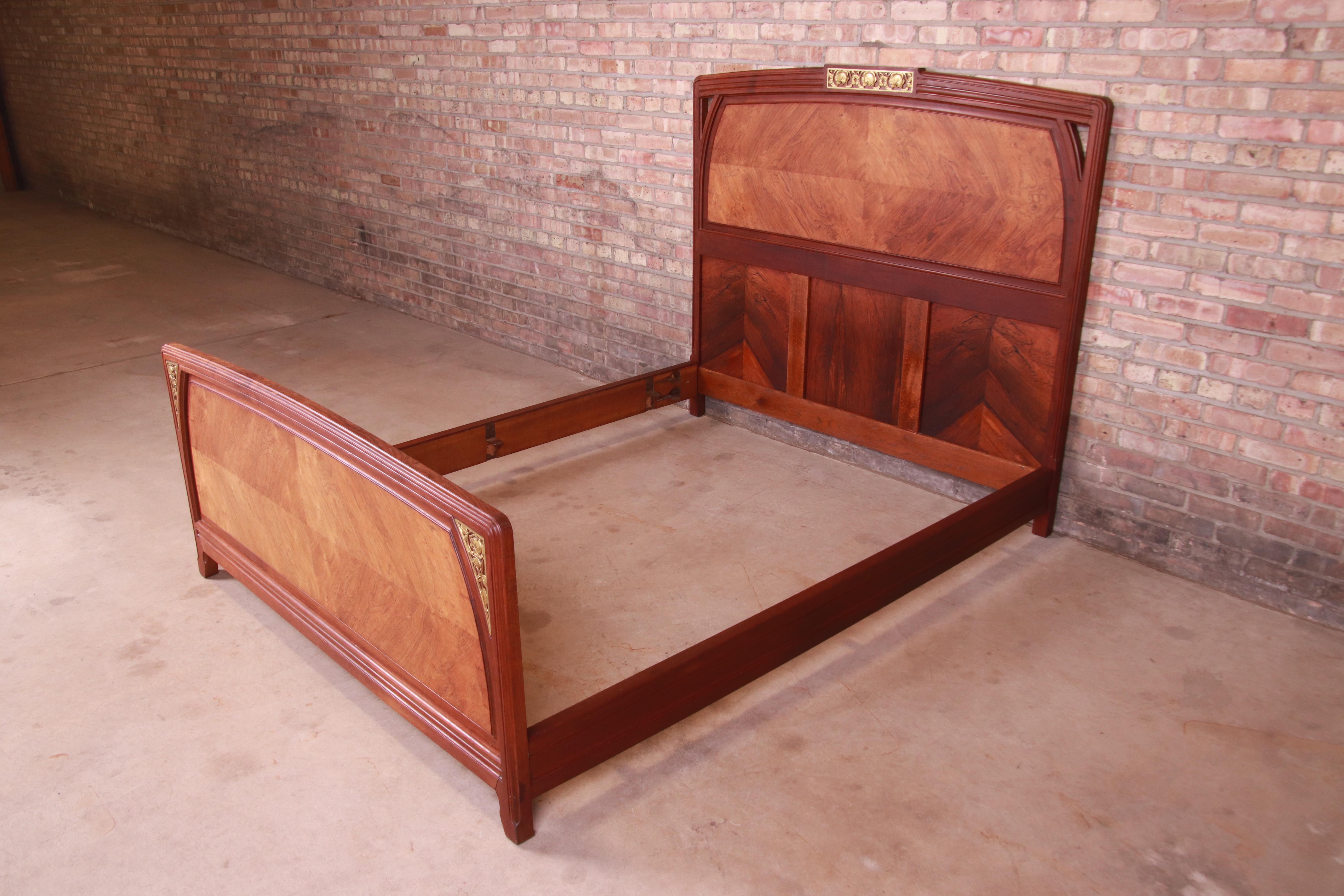 A gorgeous antique French Art Nouveau queen size bed frame

In the manner of Louis Majorelle

France, Circa 1900

Book-matched rosewood, with mounted bronze floral accents.

Measures: 63
