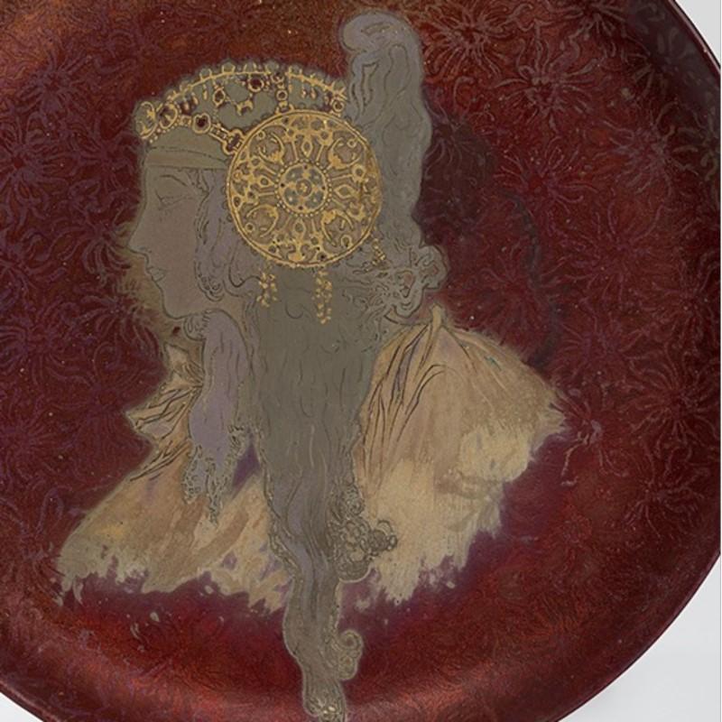 A French Art Nouveau round ceramic decorative plate by Clément Massier, depicting a Byzantine Head in iridescent enamel glazes, circa 1900s.

Signed, ''Clement Massier - Golfe Juan - (AM) MGM 1901 2''. 

(MG #17418)