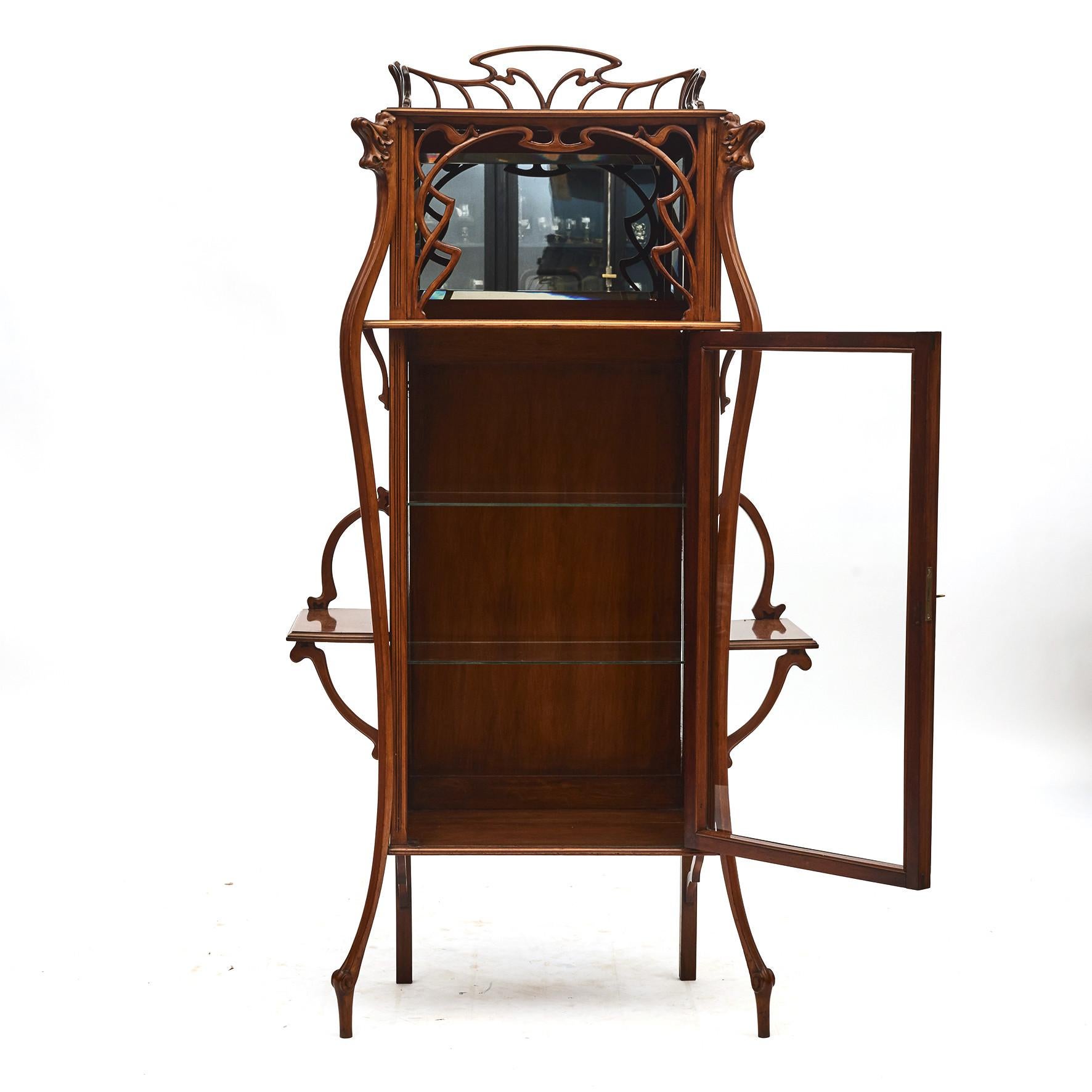 French Art Nouveau salon cabinet. We have reason to believe this cabinet was made by French Master Furniture Maker Louis Majorelle, (1859-1926).
An Art Nouveau carved pear wood salon vitrine with walnut veneered door frame.
Made in high quality