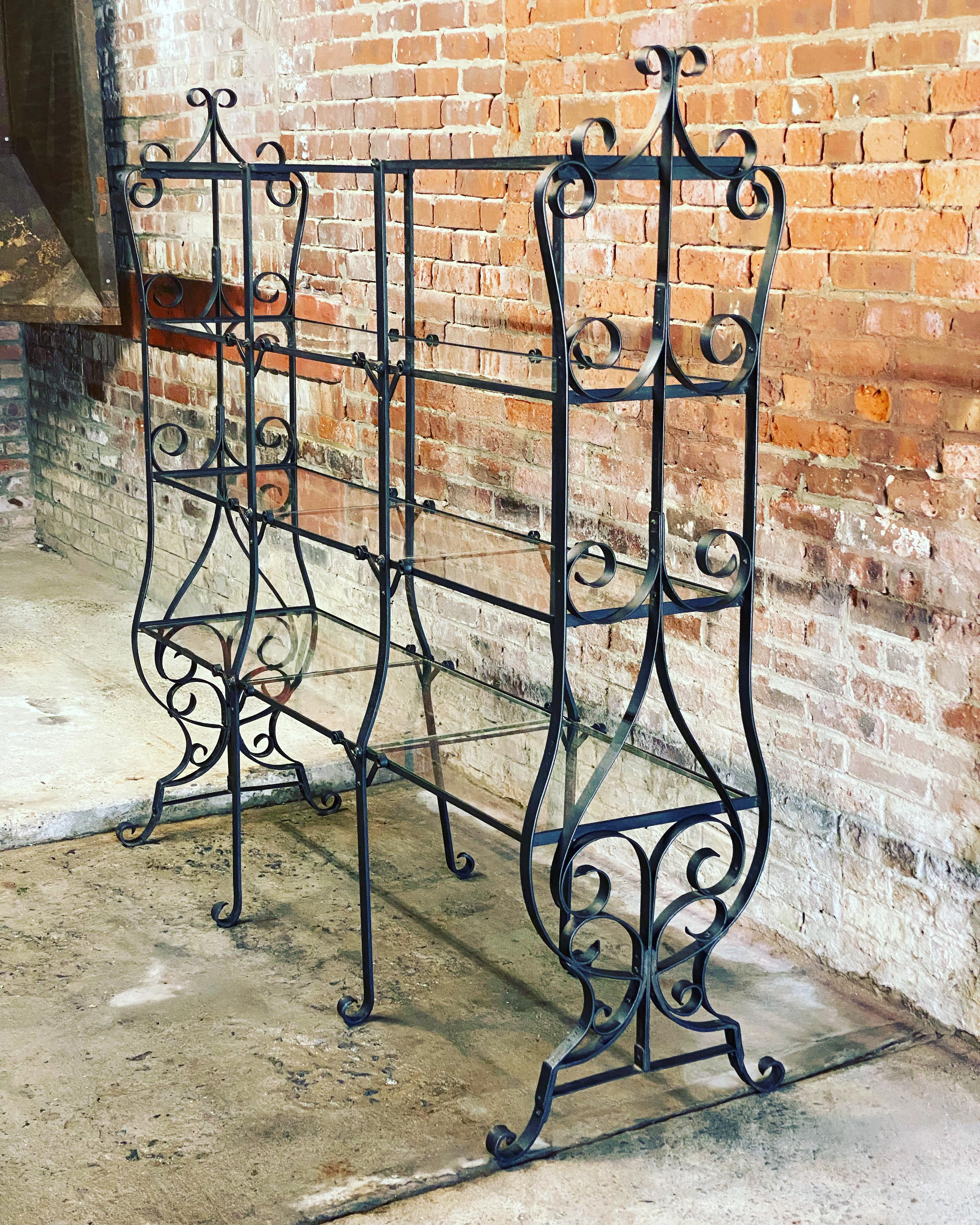 Impressive French Art Nouveau wrought iron and glass shelves etagere. This is an old  French department store display showcase. Imagine French housewares, ceramics, perfumes, plants or baked goods showcased on this beautiful shelf. Circa 1880-1900.