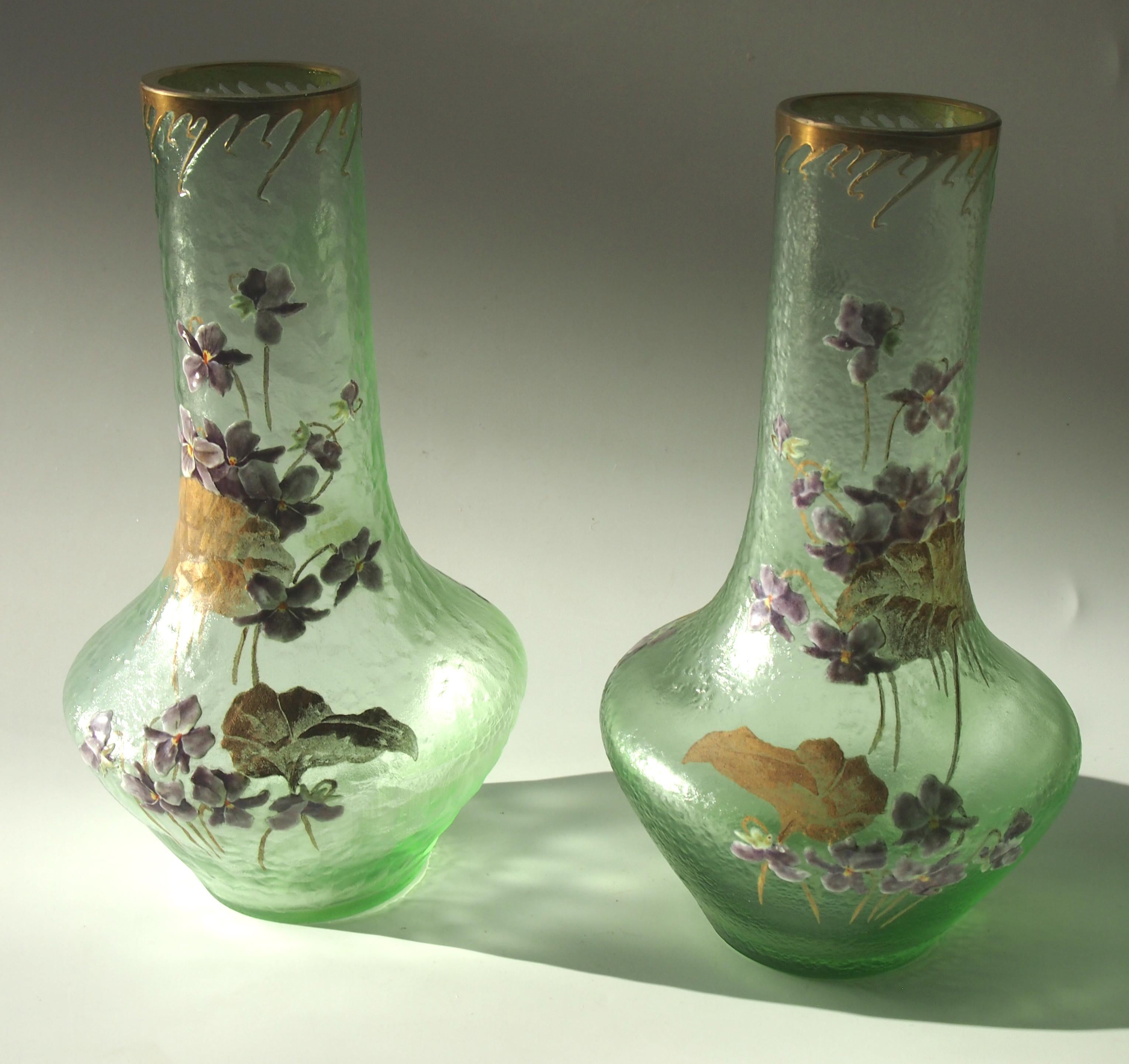 A superb signed true pair of early Art Nouveau green acid cut back Legras vases gilded and finely enameled with blooming violets in purple and white -Both signed with the Legras - Monte Joye L Co signature (slightly worn signatures).

Legras at