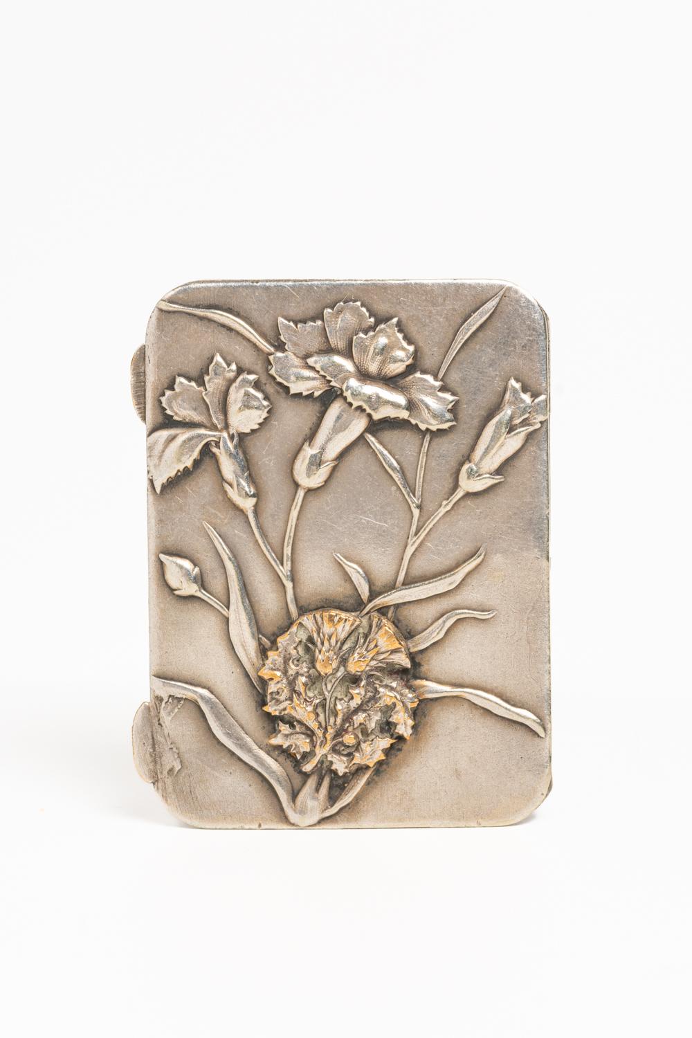 This charming French Art Nouveau pill box is dated circa 1890 and it's beautifully decorated with repousse Iris flowers and thistle on the bottom. The interior of the box is gilt washed and contains two compartments for pills. In many cultures, the
