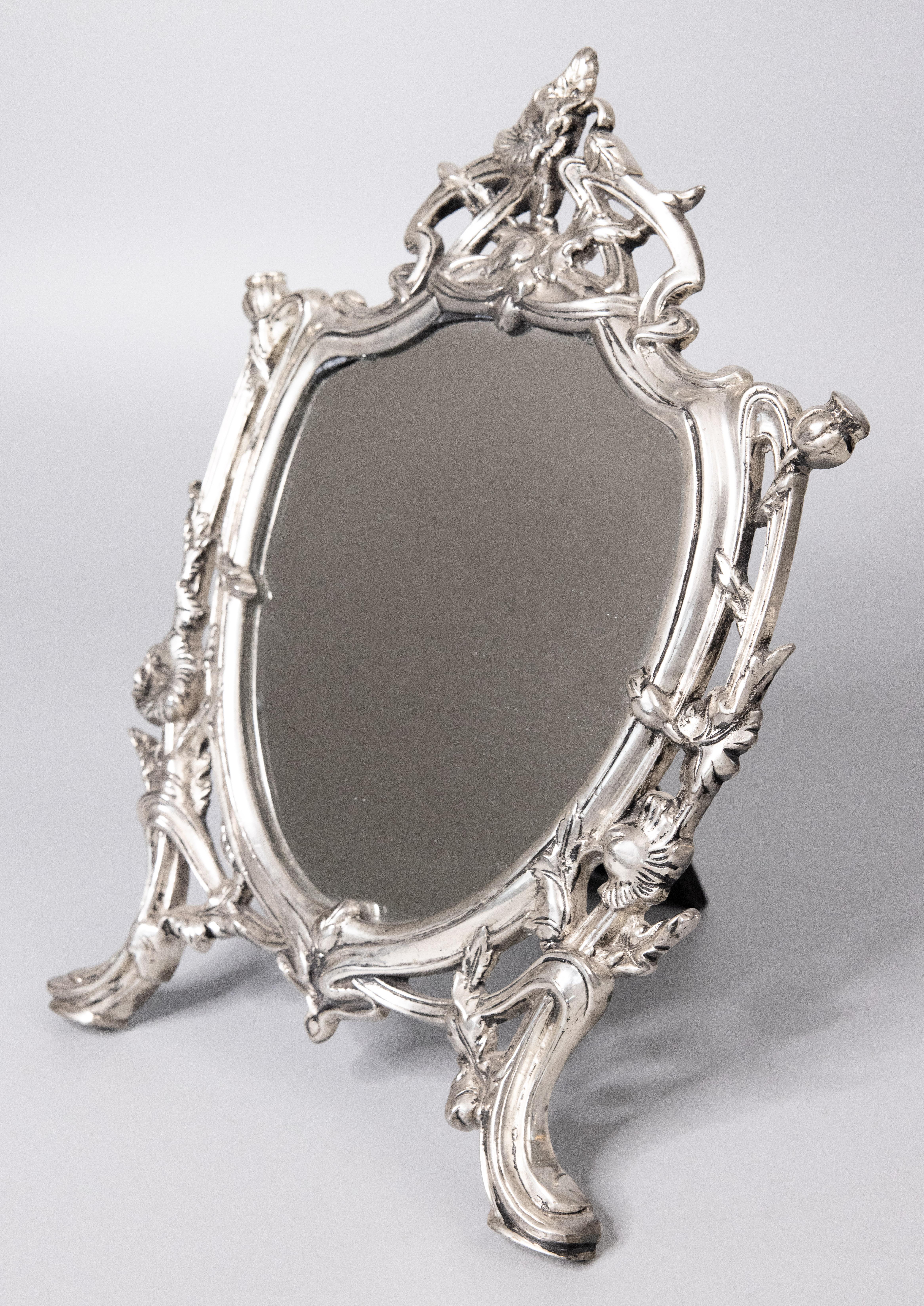 An antique French silverplated dresser tabletop vanity easel back mirror with a lovely Art Nouveau floral design, circa 1900. It would be beautiful displayed on a dresser or vanity.

DIMENSIONS
9.5ʺW × 1.25ʺD × 14ʺH
