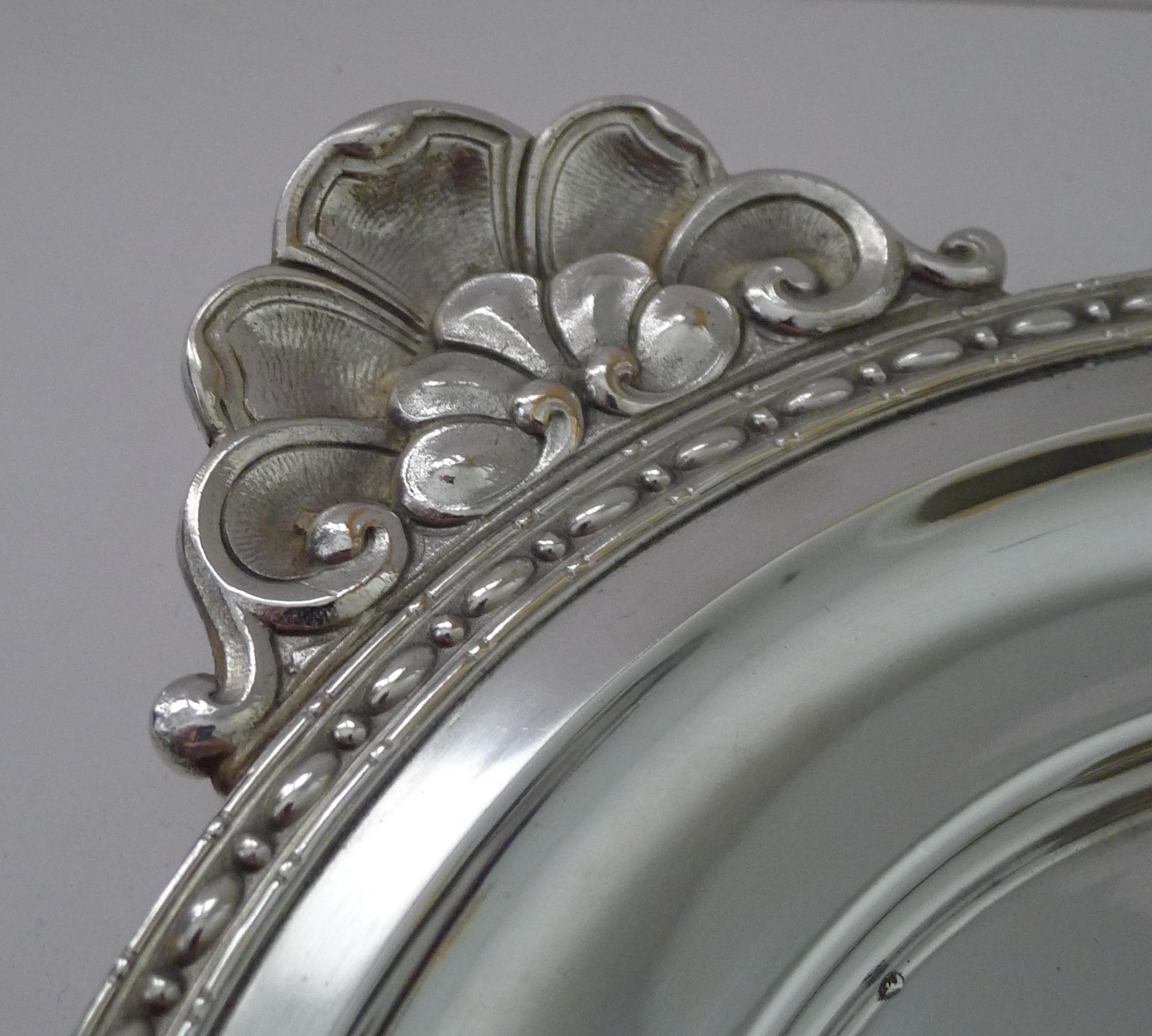 An elegant French silver plated handled tray made in silver plate in a wonderful Art nouveau design.

Professionally cleaned and polished by our silversmiths, restoring it to it's former glory ( a few stubborn marks remain commensurate with age and