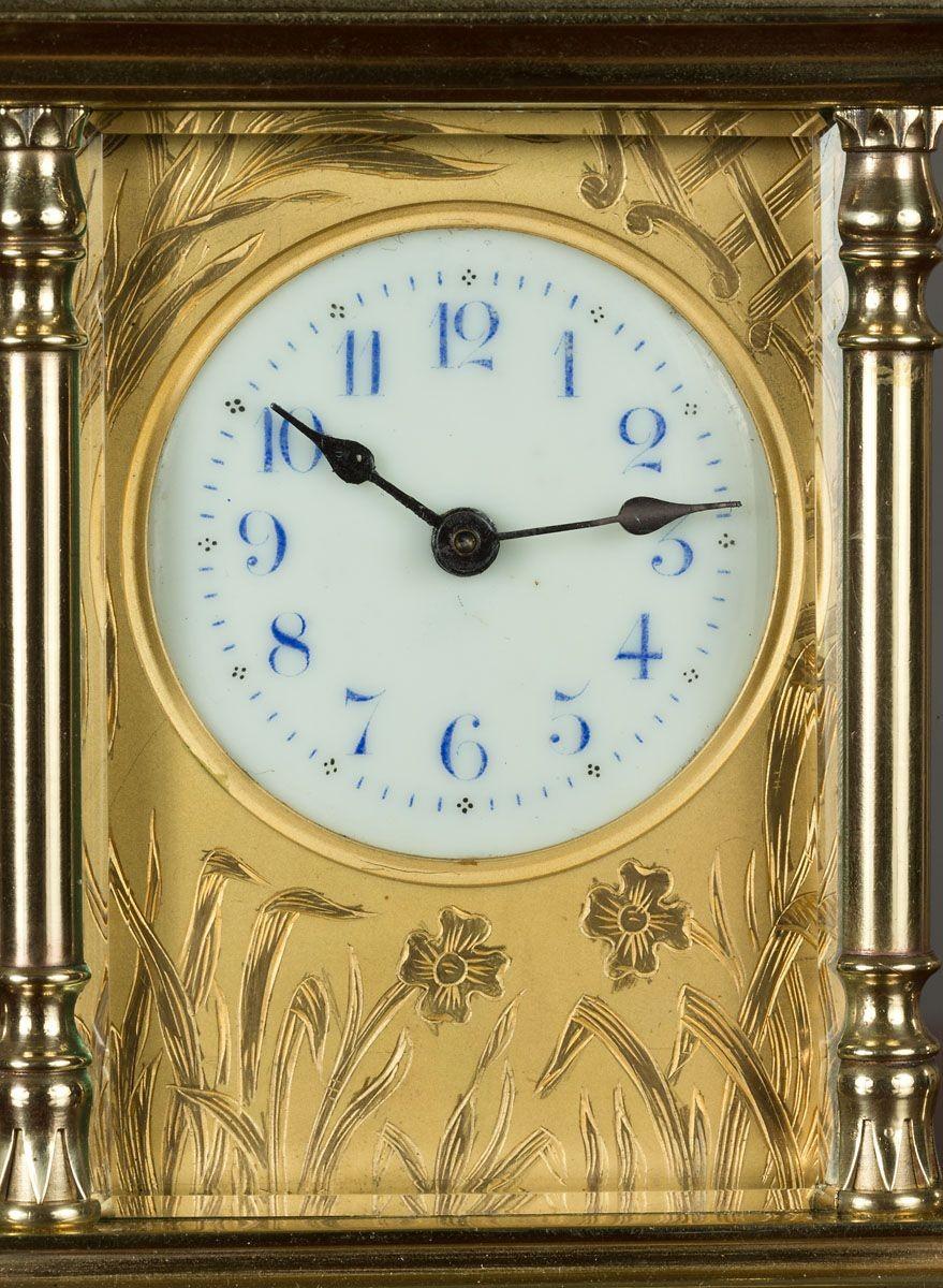 Art Nouveau brass Carriage clock with decorative handle, standing on a raised, stepped base and resting on turned brass feet.
 
Beautifully decorated gilded dial mask, enamel dial with blue Arabic numerals and original ‘blued’ steel hands.
