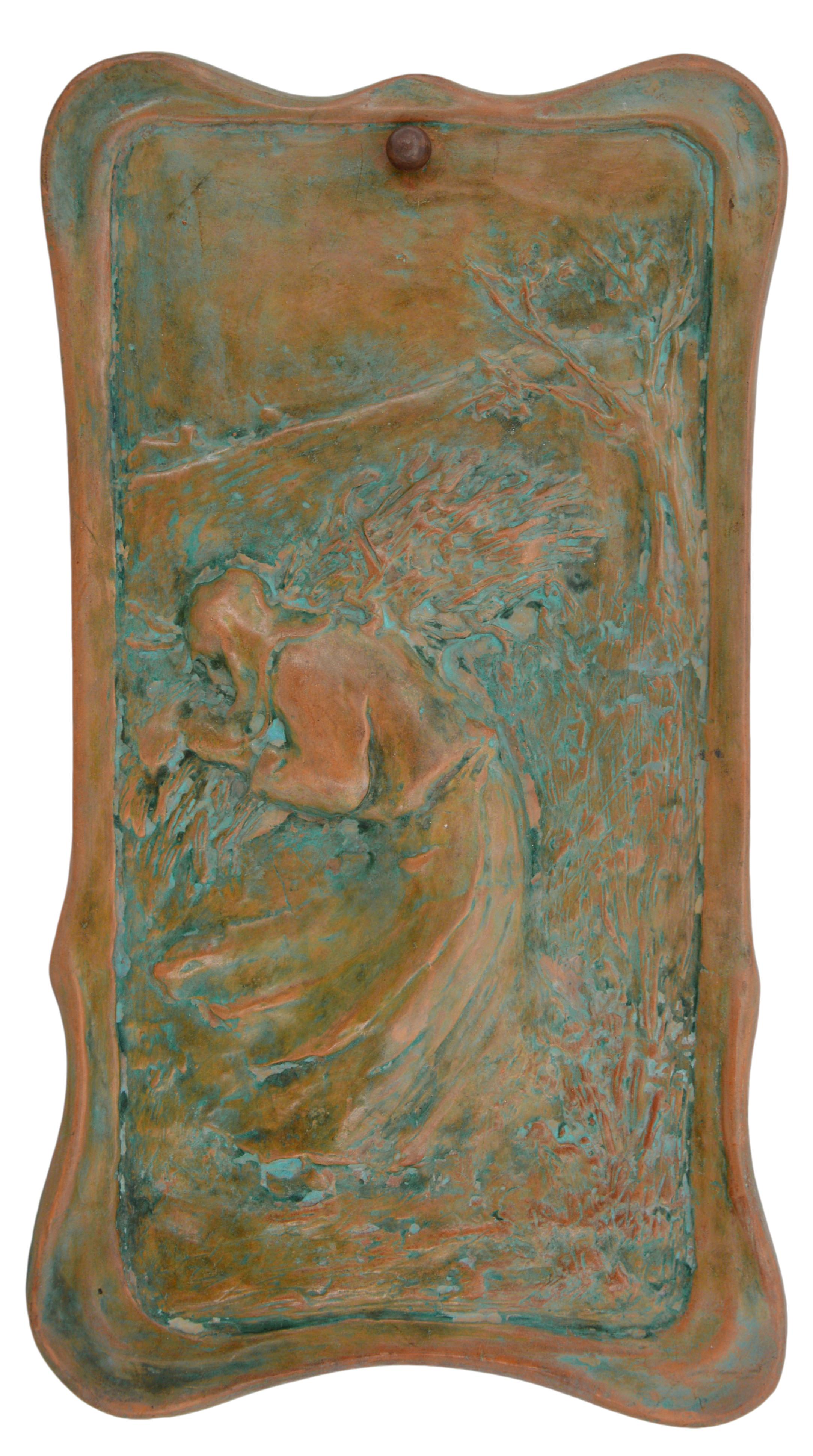 French Art Nouveau terracotta wall plaque, France, early 20th. Wood gatherer in the windy countryside. In country dress, hood and clogs, a bundle of branches on her shoulder. In the right foreground, a bush, and behind, a tree. In the distance,