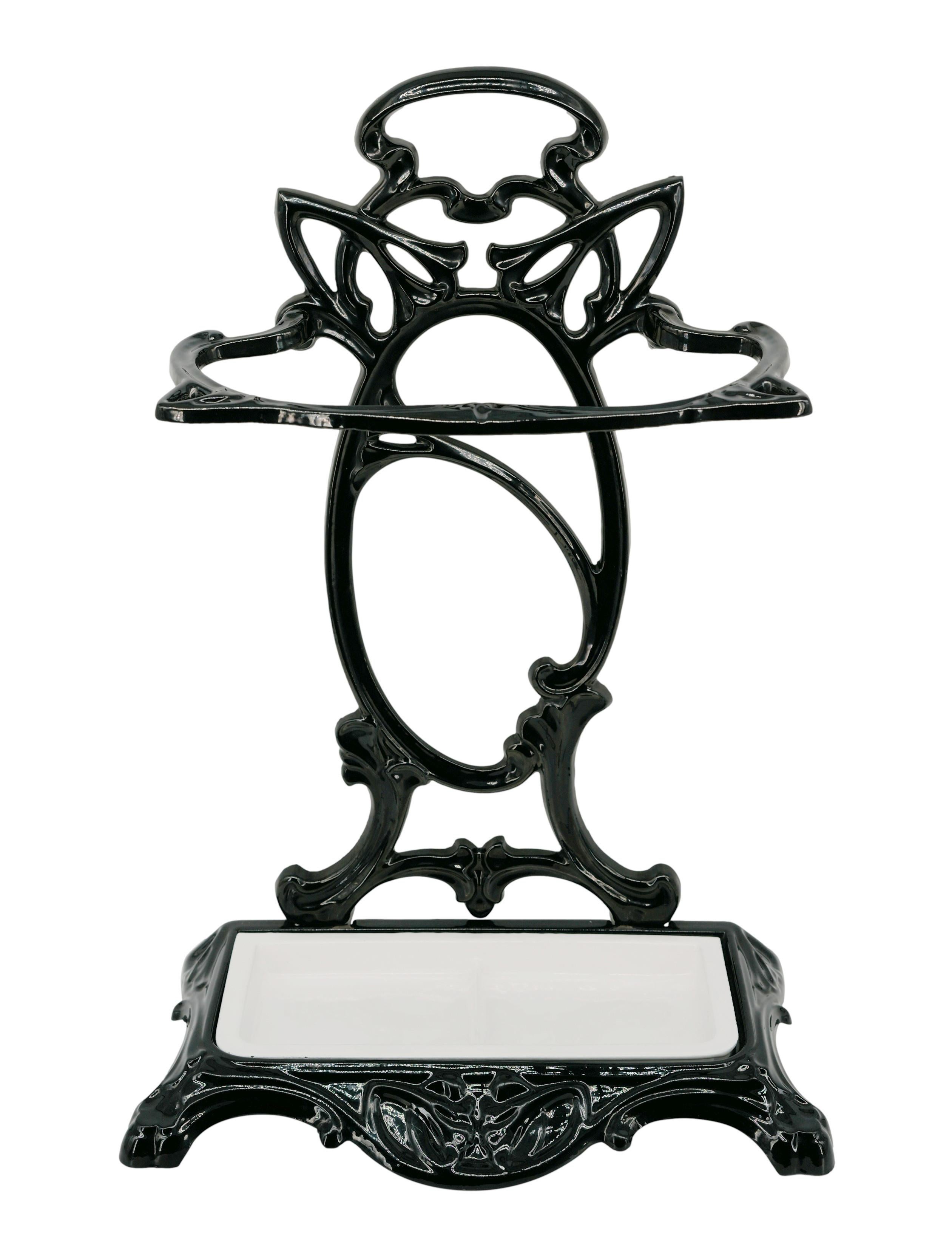 French Art Nouveau umbrella stand, France, ca.1900. Black and white enameled cast iron (fixture and tank). Height: 23.6