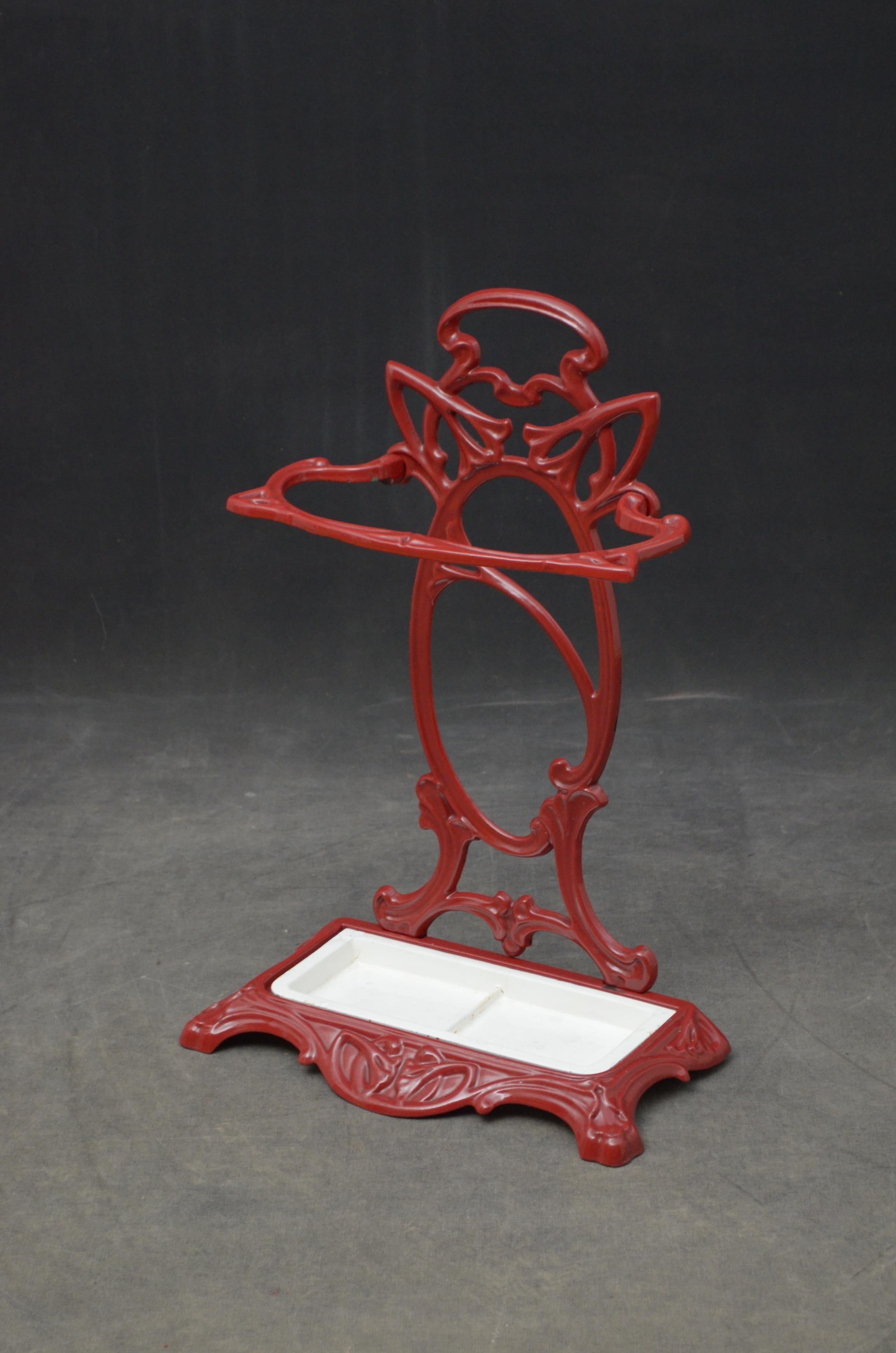 P027 An exceptional, French Art Nouveau, cast iron umbrella stand / hall stand in red with flowing organic lines, pierced design, shaped umbrella holder and removable drip tray. No breaks and in home ready condition.
 c1900
 Please view our