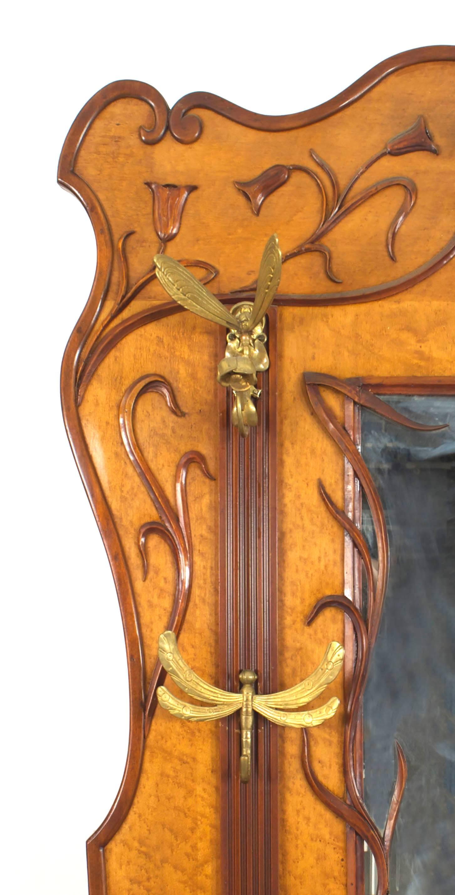 French Art Nouveau walnut and maple hatrack with a large center mirror having whiplash carving and 5 gilt bronze firefly coat hooks and lower umbrella stand with 2 brass rails.
