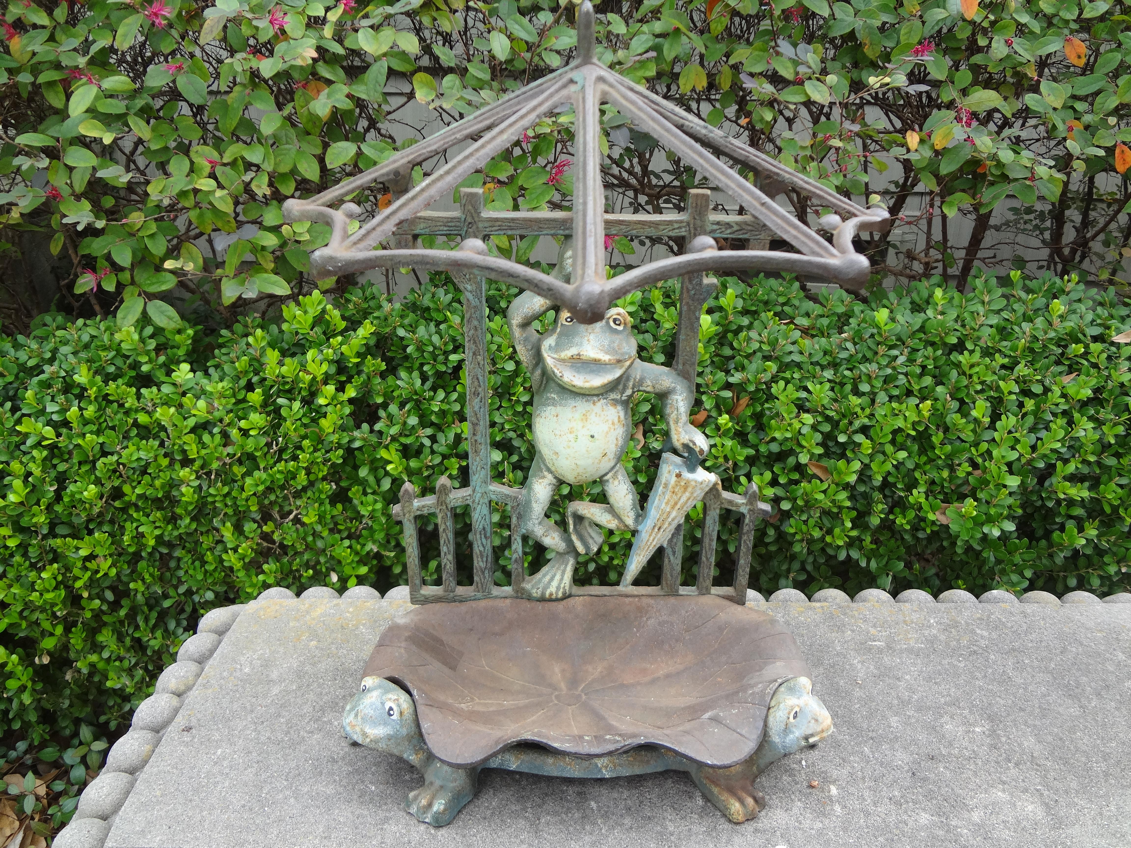 French Art Nouveau iron umbrella stand with frogs.
Whimsical French Art Nouveau patinated wrought iron umbrella stand with frogs. This unusual French iron umbrella stand has a large frog holding an umbrella with a lily pad drip pan with two