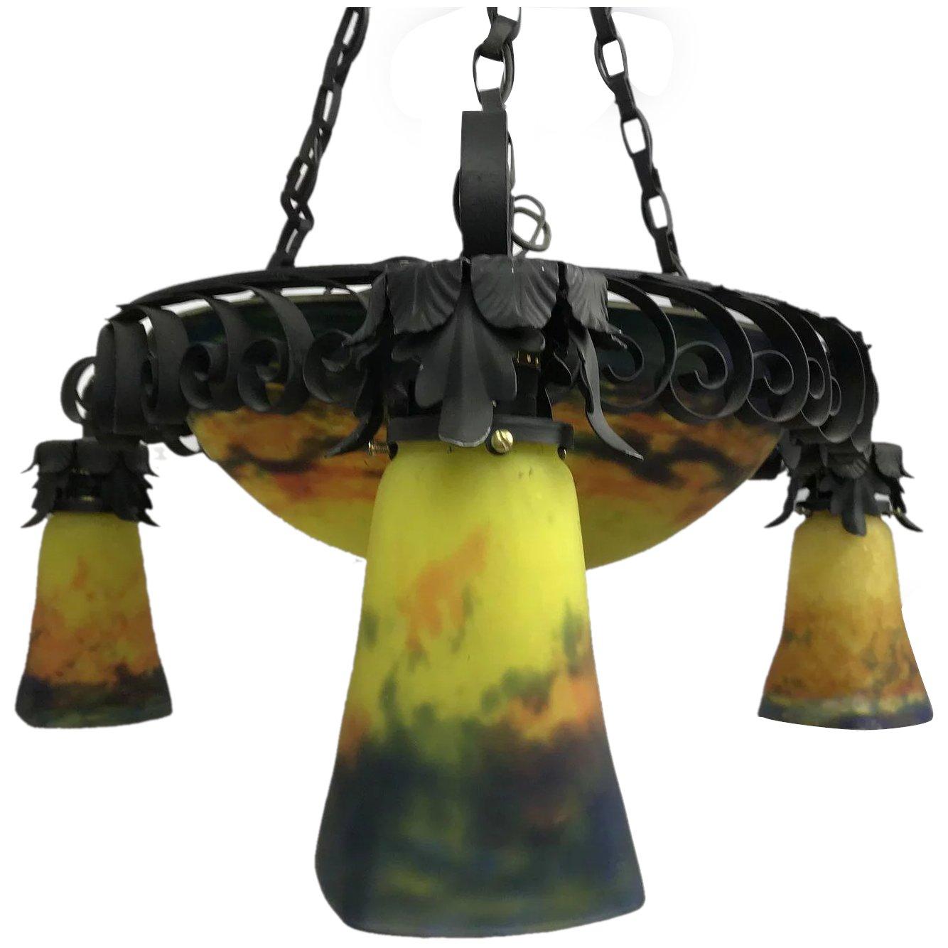 French Art Nouveau chandelier by Muller Freres.

Six lights total, three inside the large centre glass, three individual yellow, orange, and blue globes. Maximal measurements as currently configured 43 inches high, 24-inch diameter. Height could