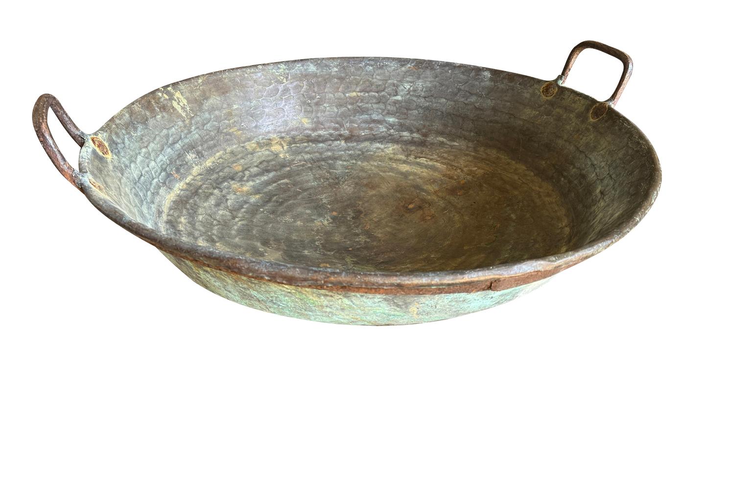 A wonderful 17th century French Arte Populaire Padelle - Copper Pan.  A Padelle is a large copper vessel used in large wood burning ovens to make nut oils.  Wonderfully crafted in very heavy gauge hammered copper with iron handles.  Fabulous patina.
