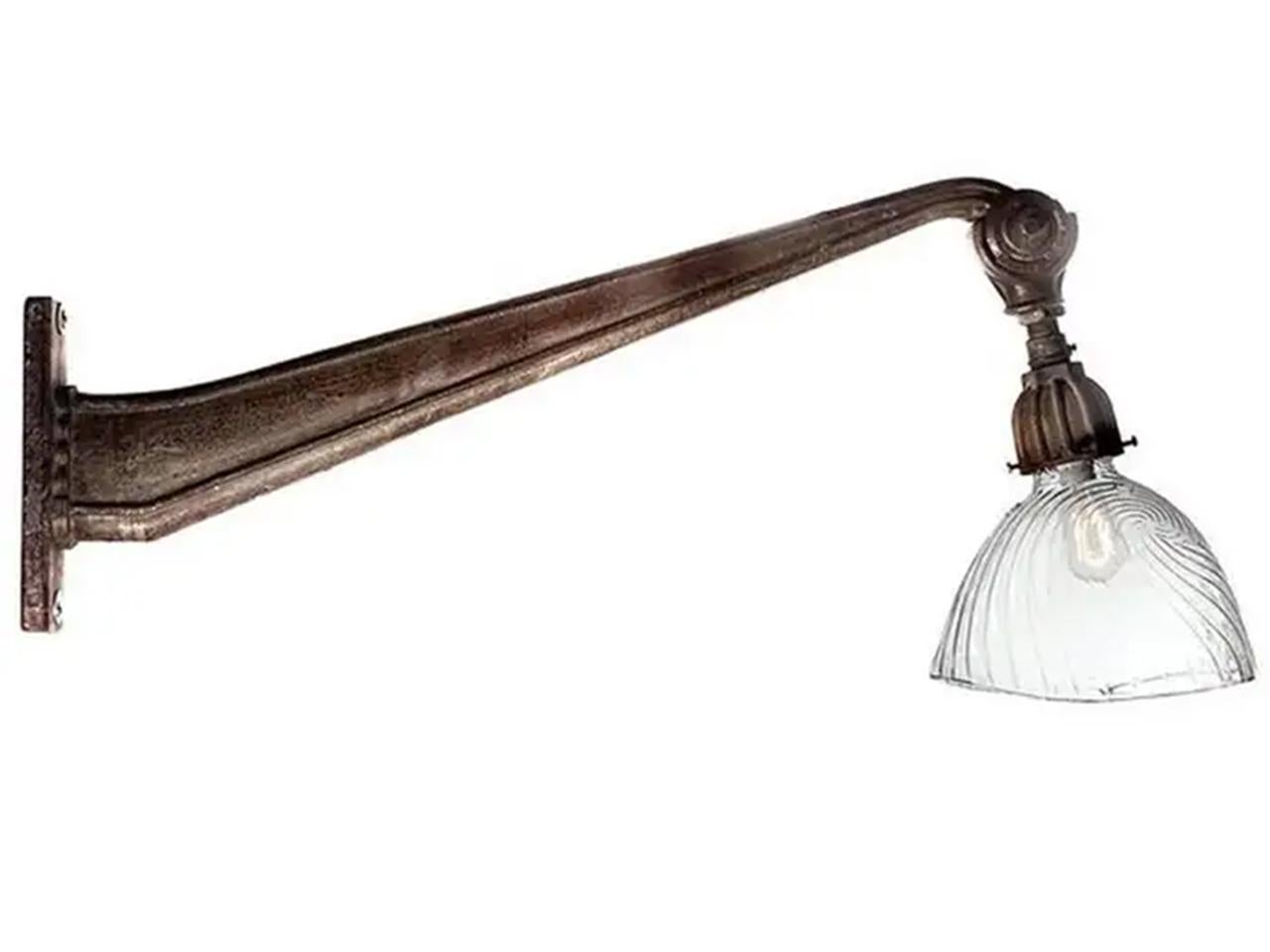 This French arm is beautiful cast iron with an original patina. The end of the arm has an angle adjustment to point the lamp and shade. The look is very clean and a bit Art Deco. The shade is one of the largest mercury glass examples that was ever