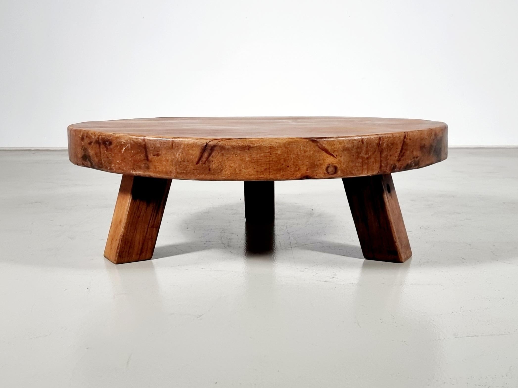 Impressionnante table basse faite à la main en très bon état d'origine.

La table est fabriquée en chêne français massif.

Le plateau rond et épais a une belle couleur chaude et est composé de poutres étroites, ce qui donne un bel effet.

La base