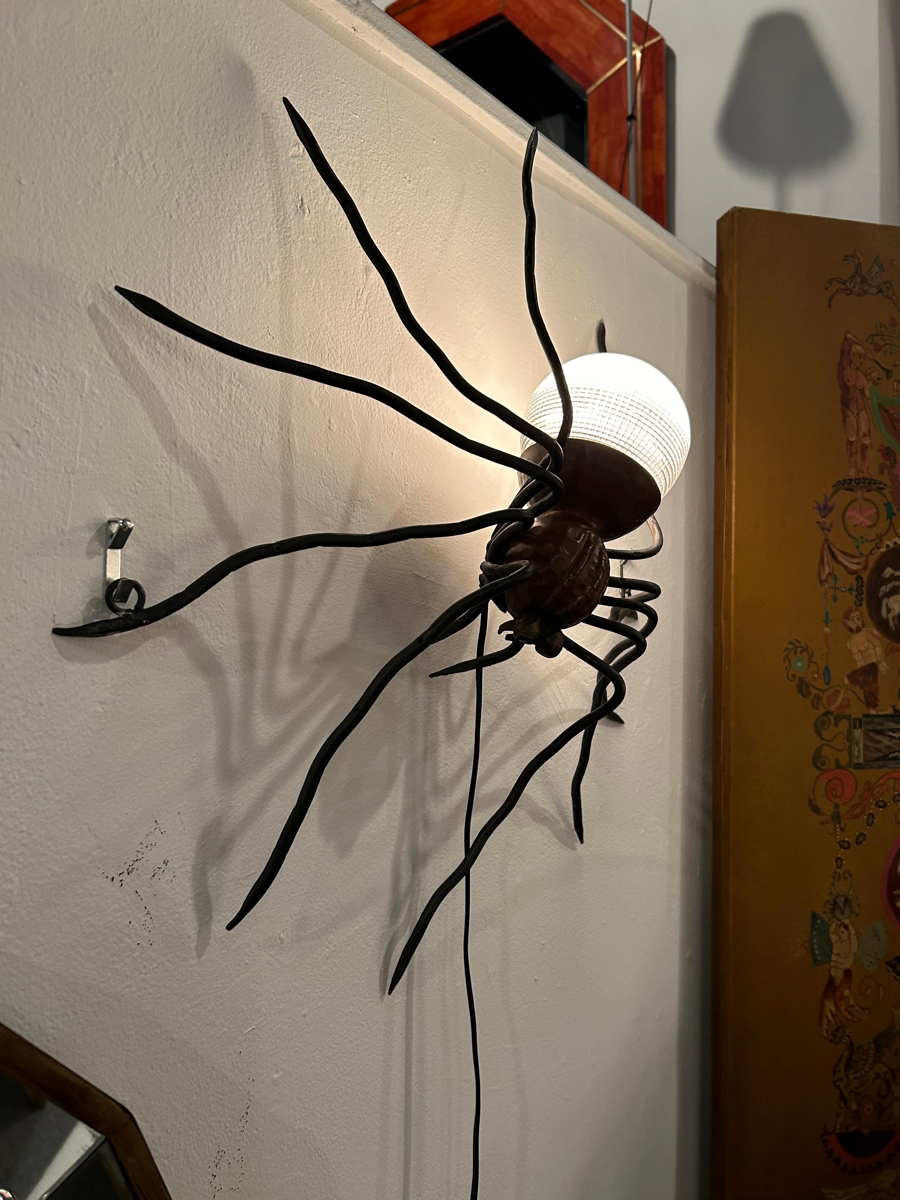 Incredible work of art wall light that’s a hand made copper, iron and art glass spider.  The thing in the room that steals the show!  Unsigned 
25 watt bulb