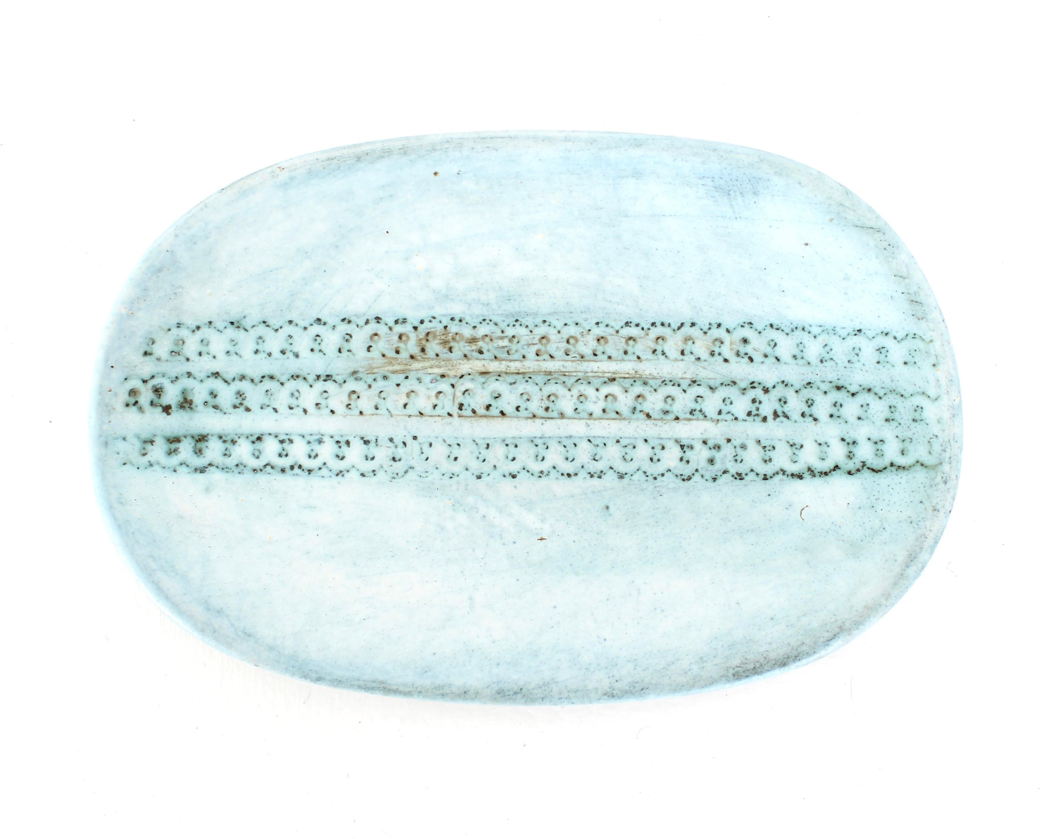 Hand-thrown ceramic dish glazed in shades of blue green with incised and engraved lines, and stamping decoration. 
Ceramic signed by the French ceramicists 2 potiers (Deux Potiers) 
Michelle et Jacques Serre.
France, circa 1960. 
Bibliography: