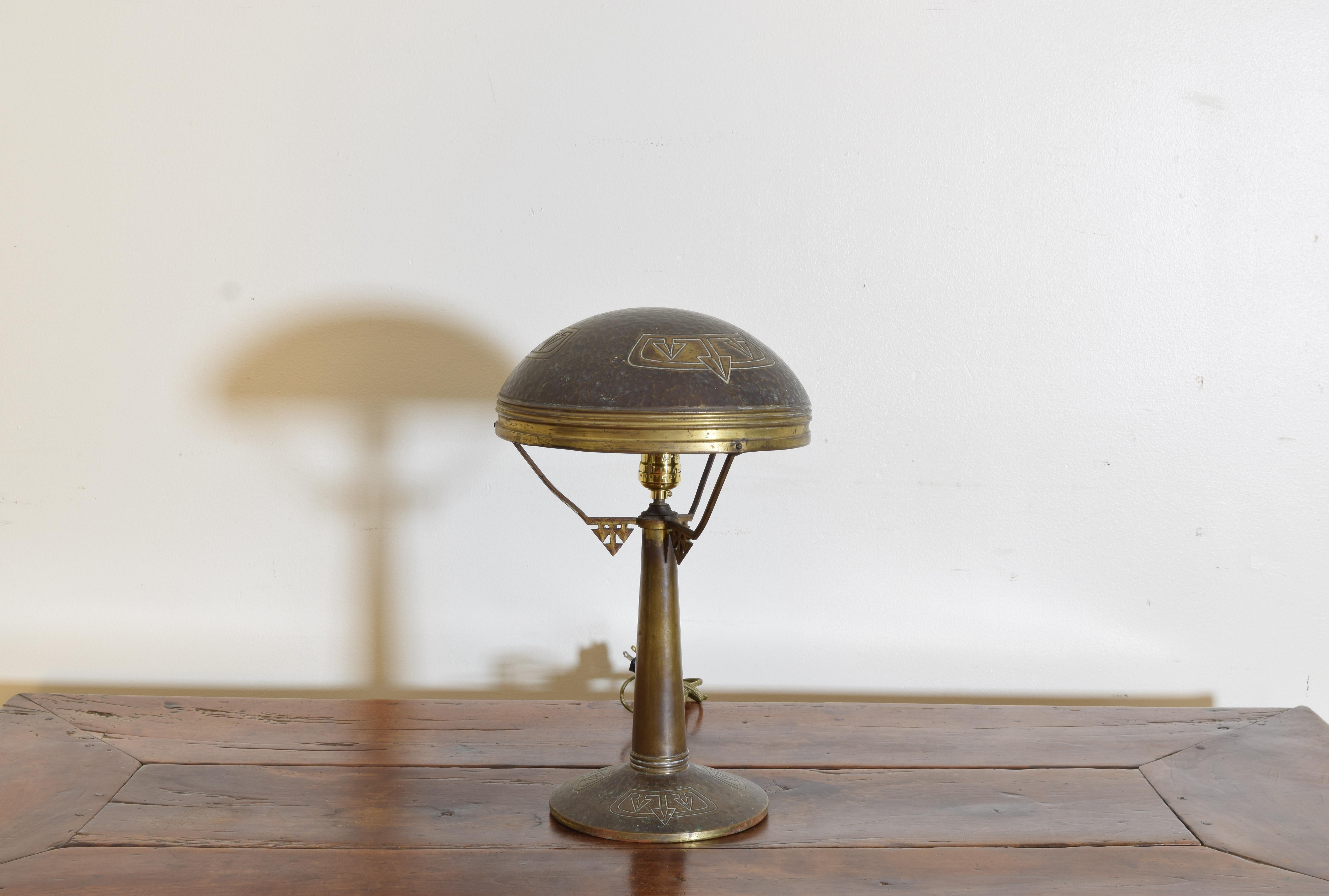 Having a domed shade with a decorative design raised on a tapering standard with geometric stretchers atop a disk-form base