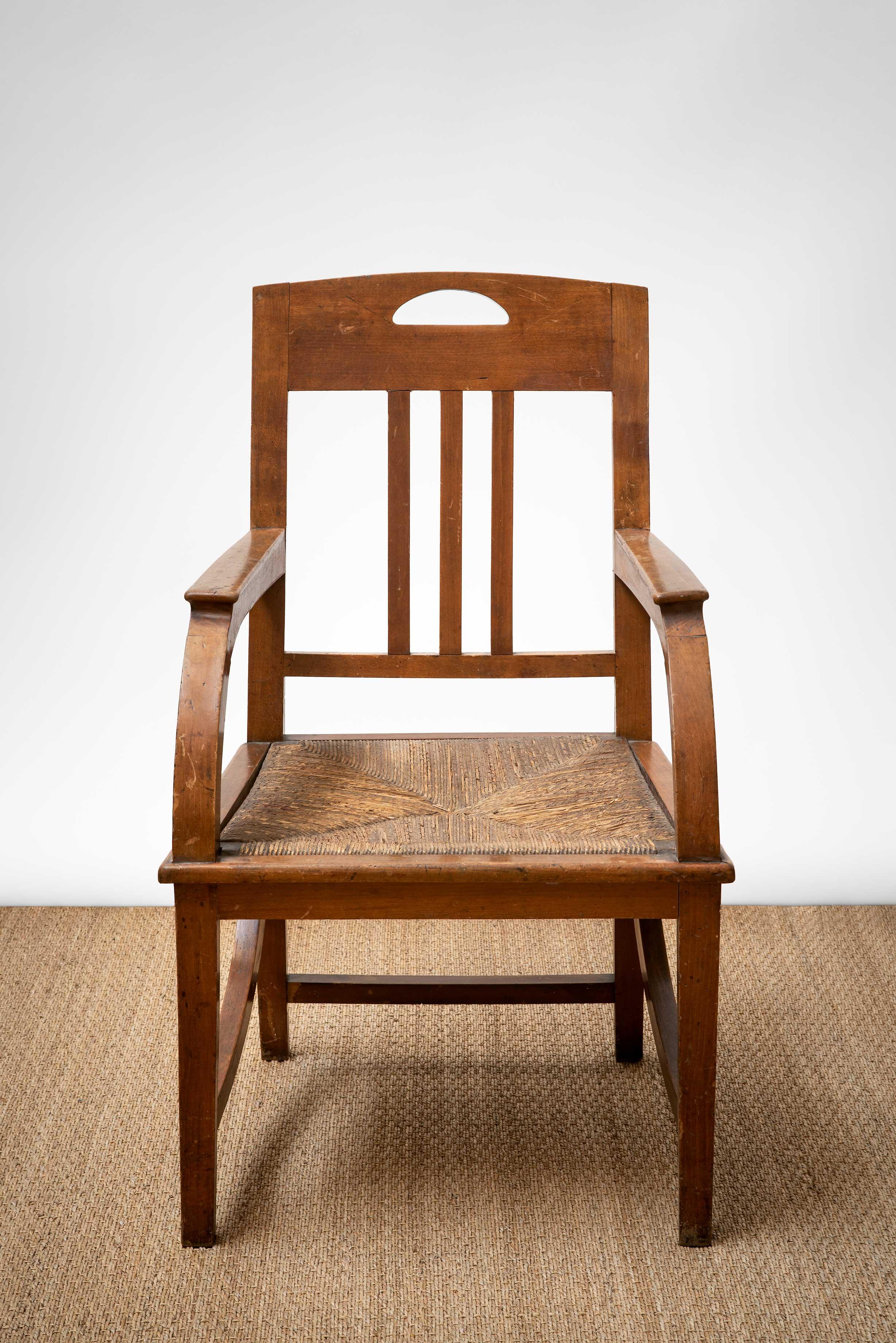 French Arts + Crafts walnut frame armchair with new rush seat, France, early 20th century.