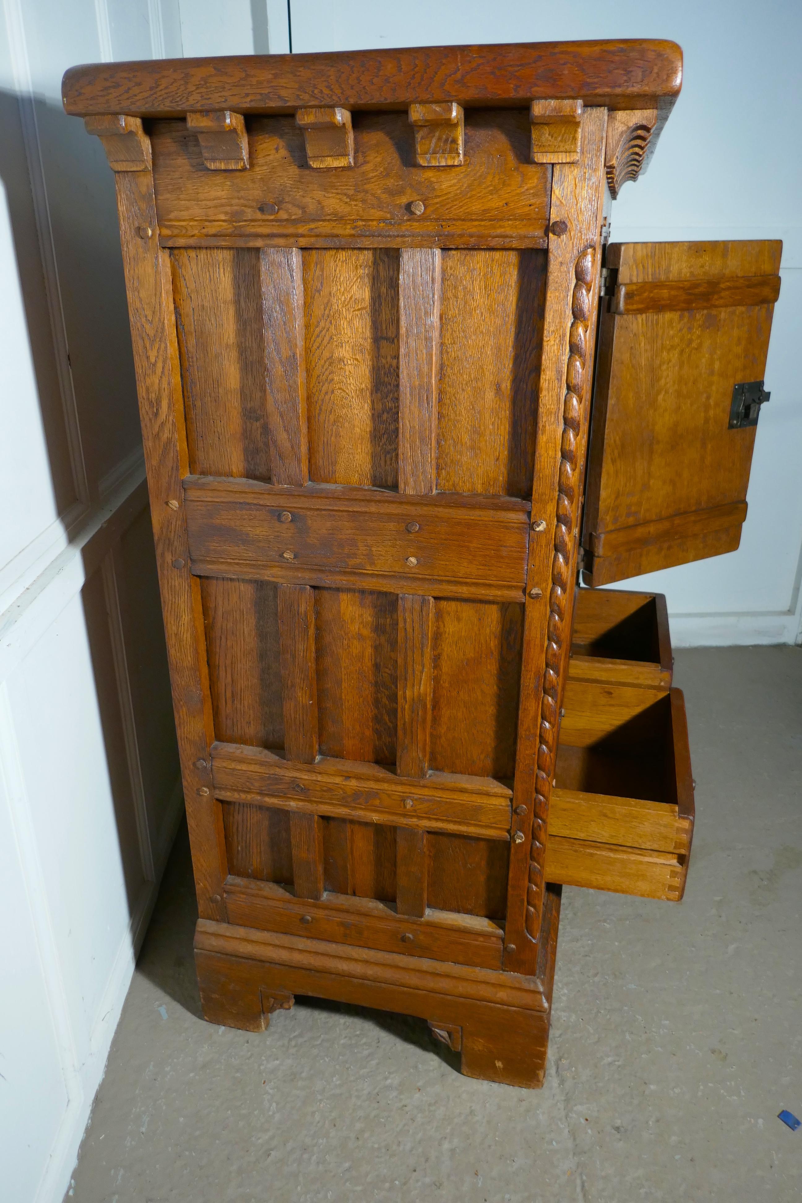 French Arts & Crafts Gothic Carved Golden Oak Cupboard 

This is an exceptional fine quality carved oak cupboard, in the Arts & Crafts style and dates from the 1st half of the 20th century and it has been carved by a master craftsman.

The door