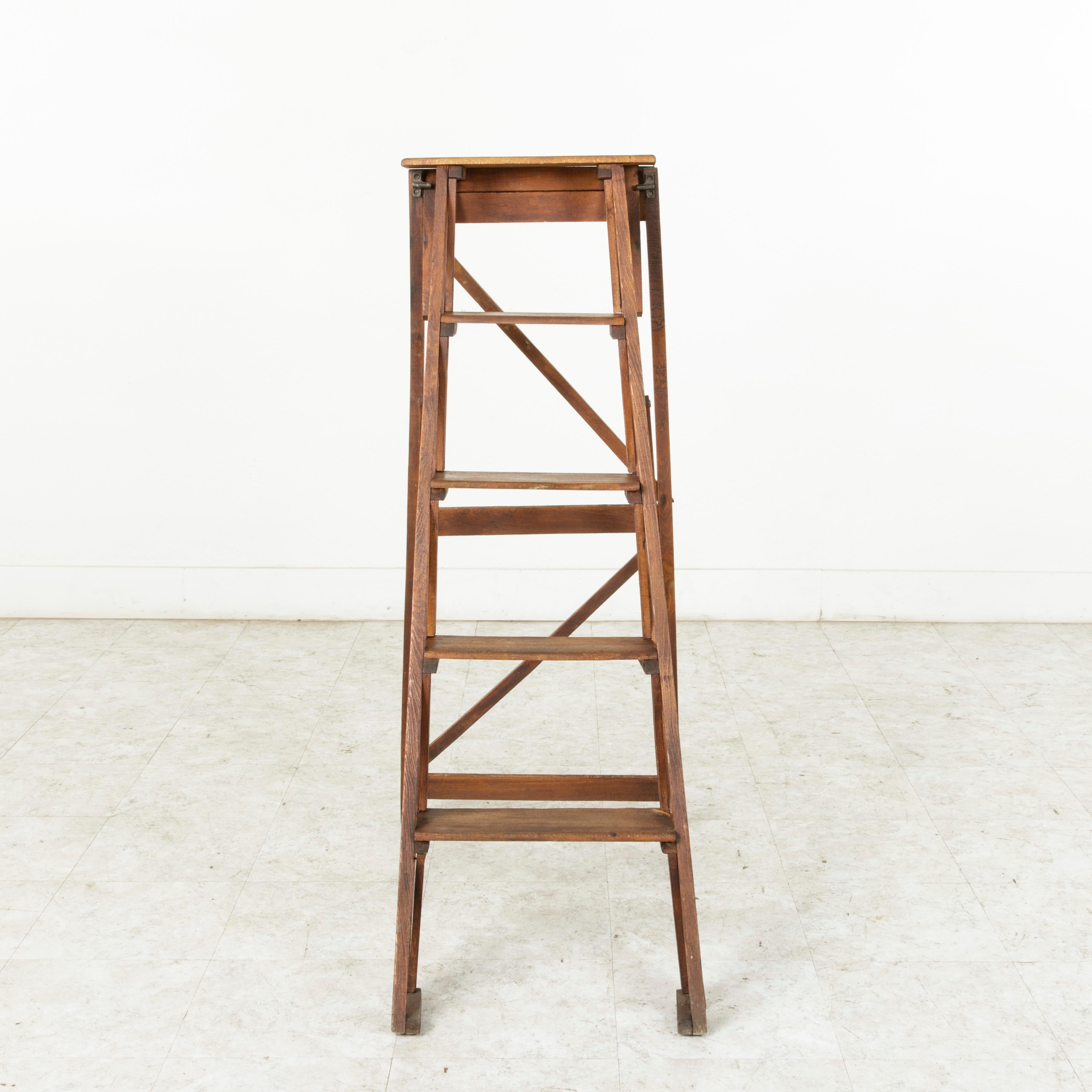 Originally used in a French library, this folding ladder constructed of ash would be a handsome addition to any space with hard to reach shelving. While still being utilitarian, this ladder also maintains an artistic presence that allows its five