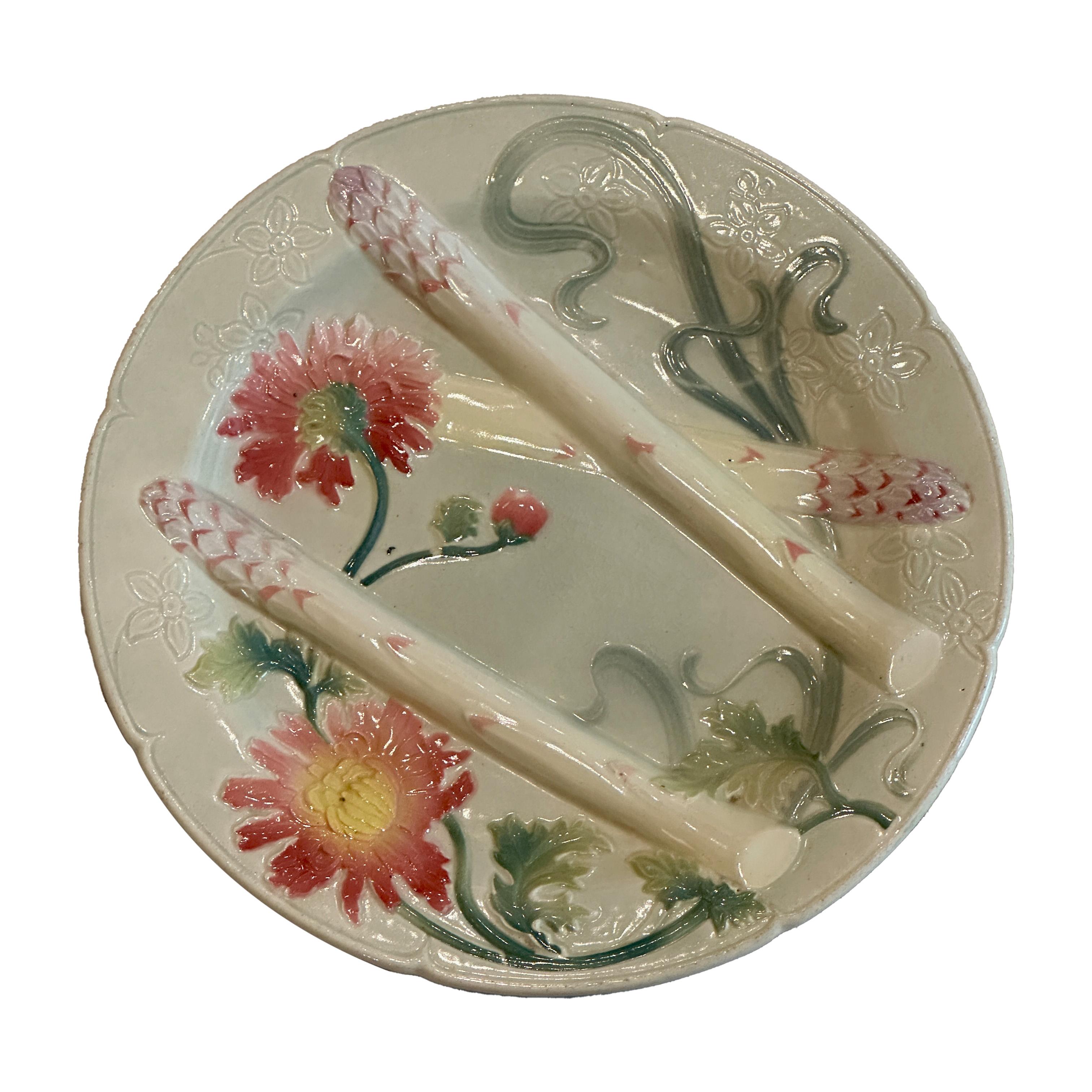 Discover a stunning piece of Aesthetic Movement French faïence: an asparagus plate by Keller & Guérin, St. Clément, circa 1890–1900, in the Art Nouveau style. This exquisite plate features a captivating border of chrysanthemum flower heads