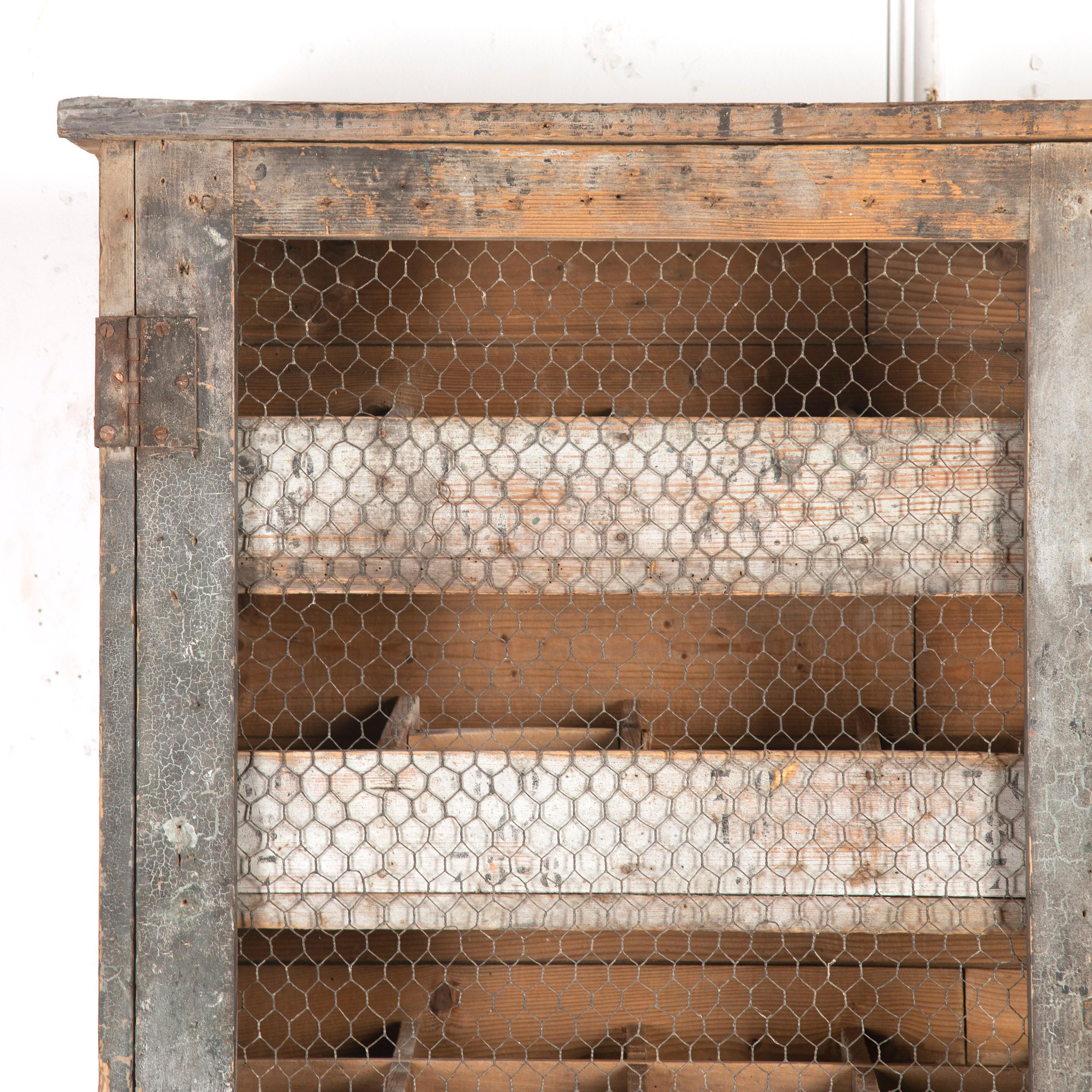 Wonderful French 20th century atelier's storage unit.

This unit has a great industrial aesthetic and originally came from a Parisian workshop.

It has a simple wooden framework and wire netting over the doors. Retaining charming splashes of old